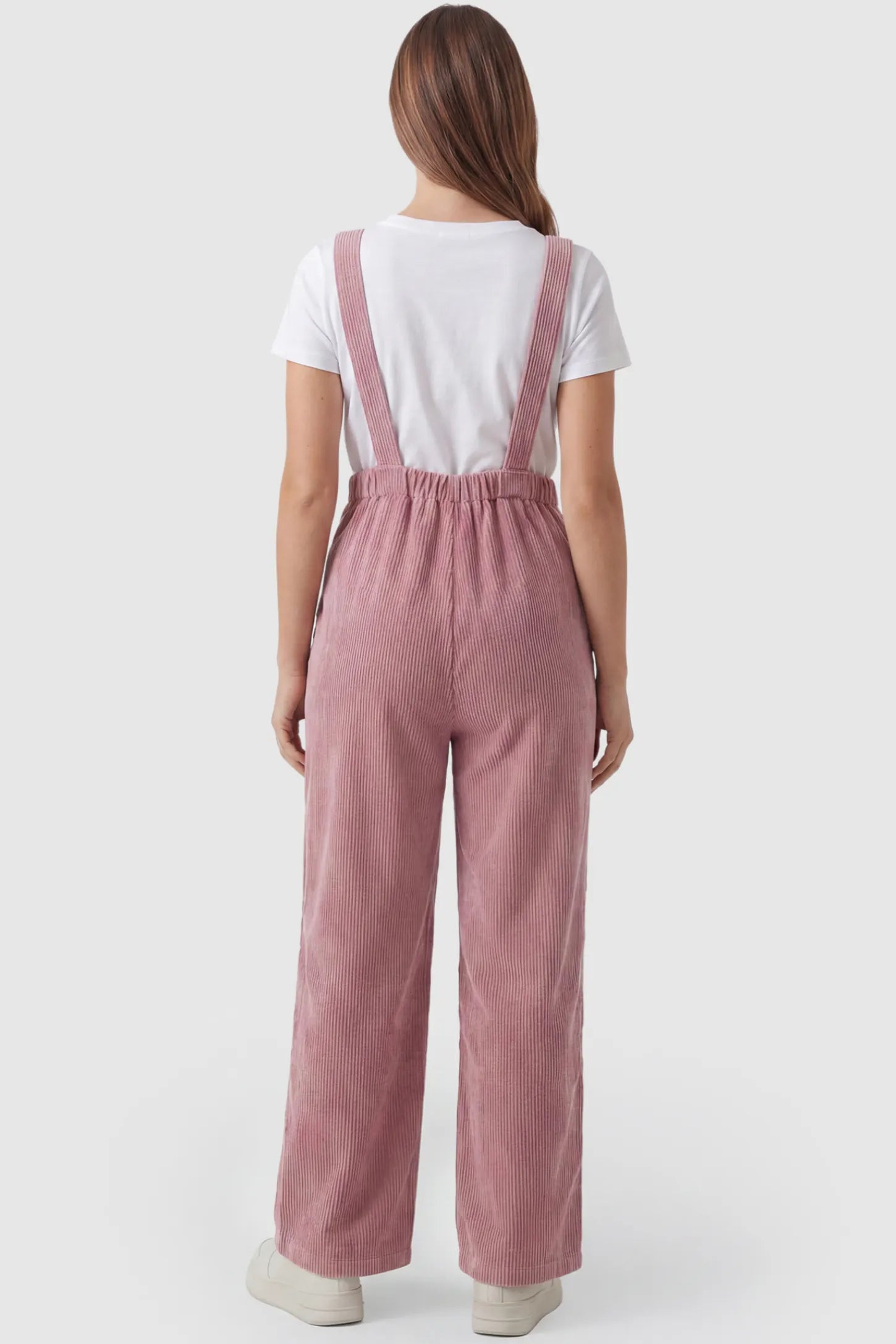 Corduroy Wide Leg Maternity Jumpsuit Corduroy Wide-Leg Maternity Jumpsuit in Pink featuring a relaxed wide-leg silhouette on a pregnant model, back view.