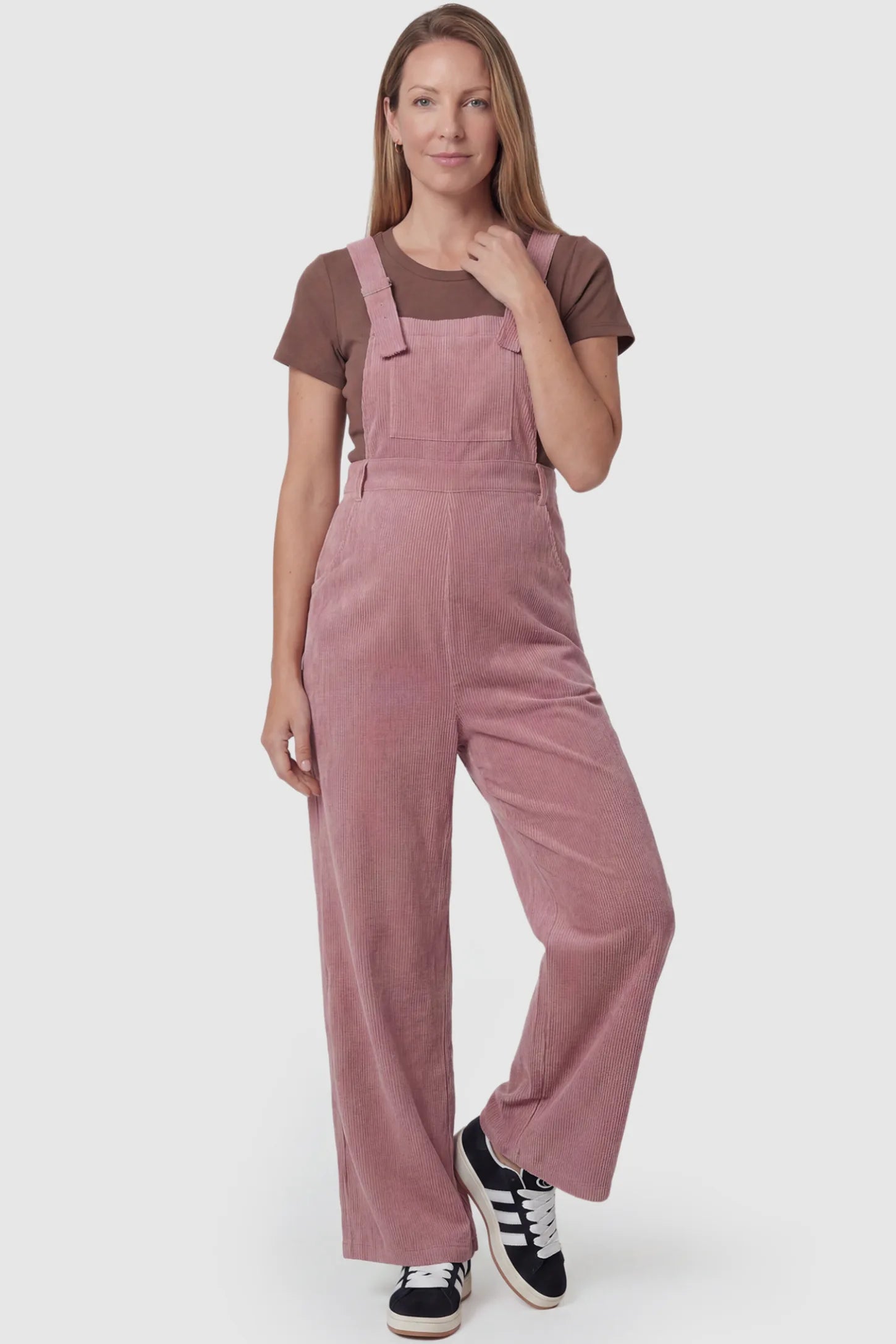 Corduroy Wide Leg Maternity Jumpsuit Corduroy Wide-Leg Maternity Jumpsuit in Pink featuring a relaxed wide-leg silhouette on a postpartum model, front view.