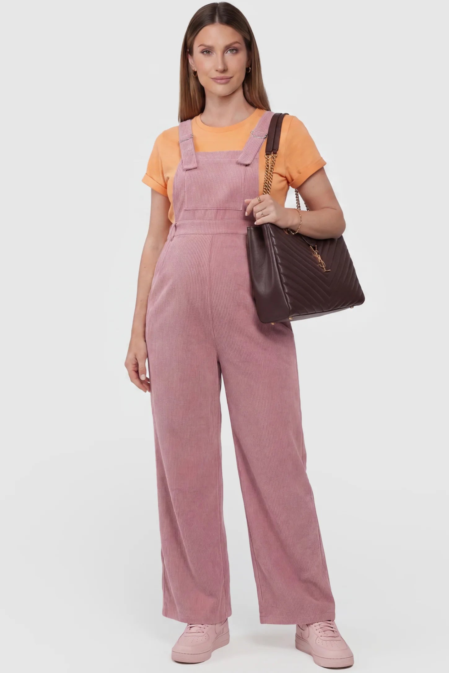 Corduroy Wide-Leg Maternity Jumpsuit in Pink featuring a relaxed wide-leg silhouette on a pregnant model, front view.