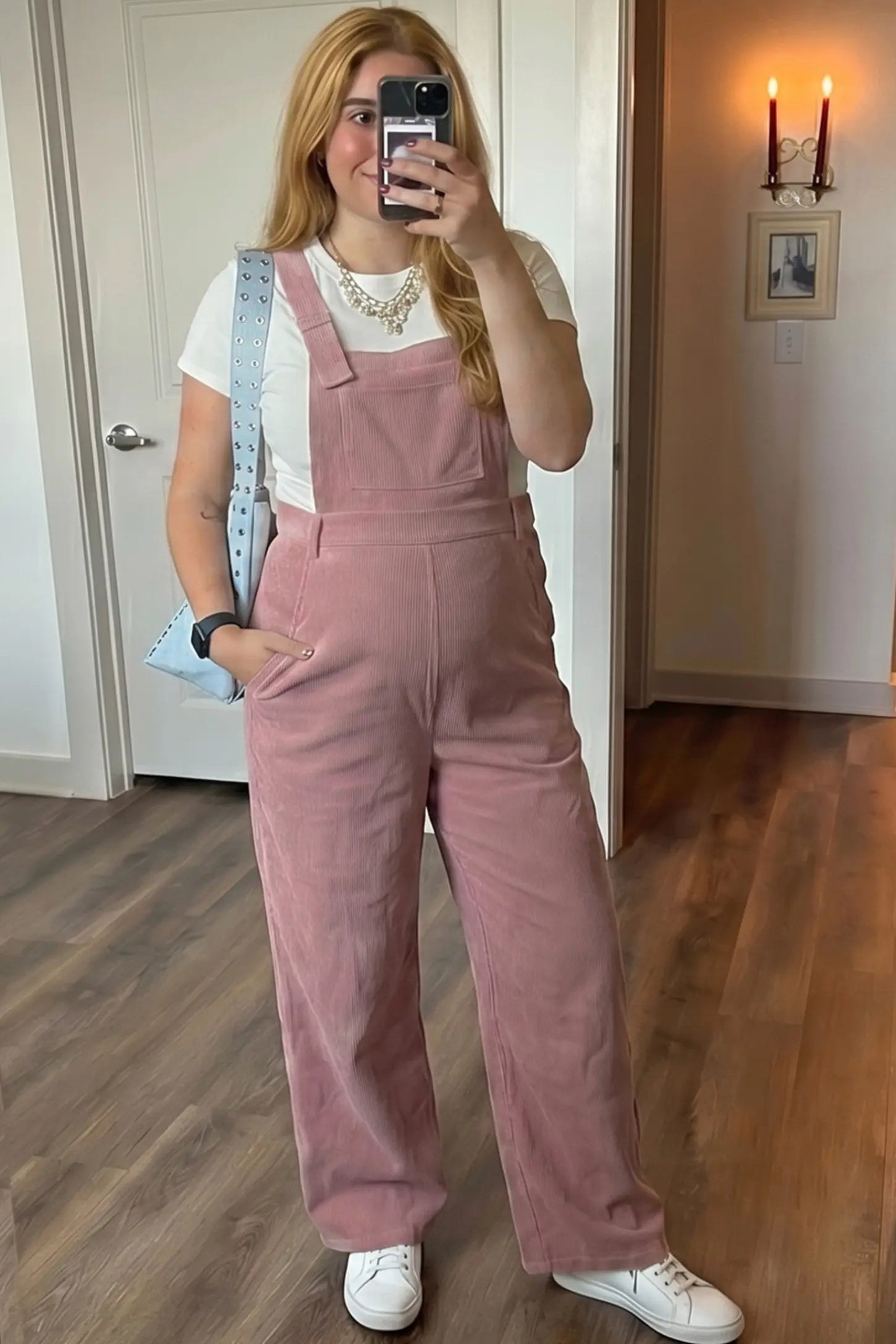 Corduroy Wide Leg Maternity Jumpsuit Corduroy Wide-Leg Maternity Jumpsuit in Pink featuring a relaxed wide-leg silhouette on a pregnant woman in indoor setting, front view.