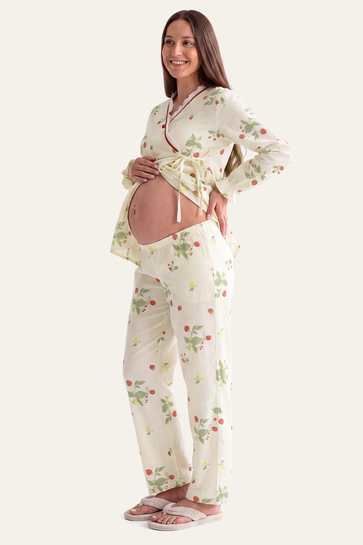 Cotton Long Sleeve Top & Pants Maternity Pajama Set Full side profile view of a pregnant model displaying the accommodating bump fit and relaxed drape of the strawberry cotton long sleeve pajama set and pants.