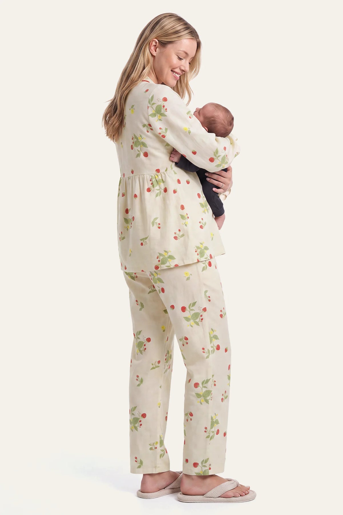 Cotton Long Sleeve Top & Pants Maternity Pajama Set Full studio shot of a mother holding her newborn baby in her arms while wearing the soft cotton strawberry print maternity and nursing pajama set.
