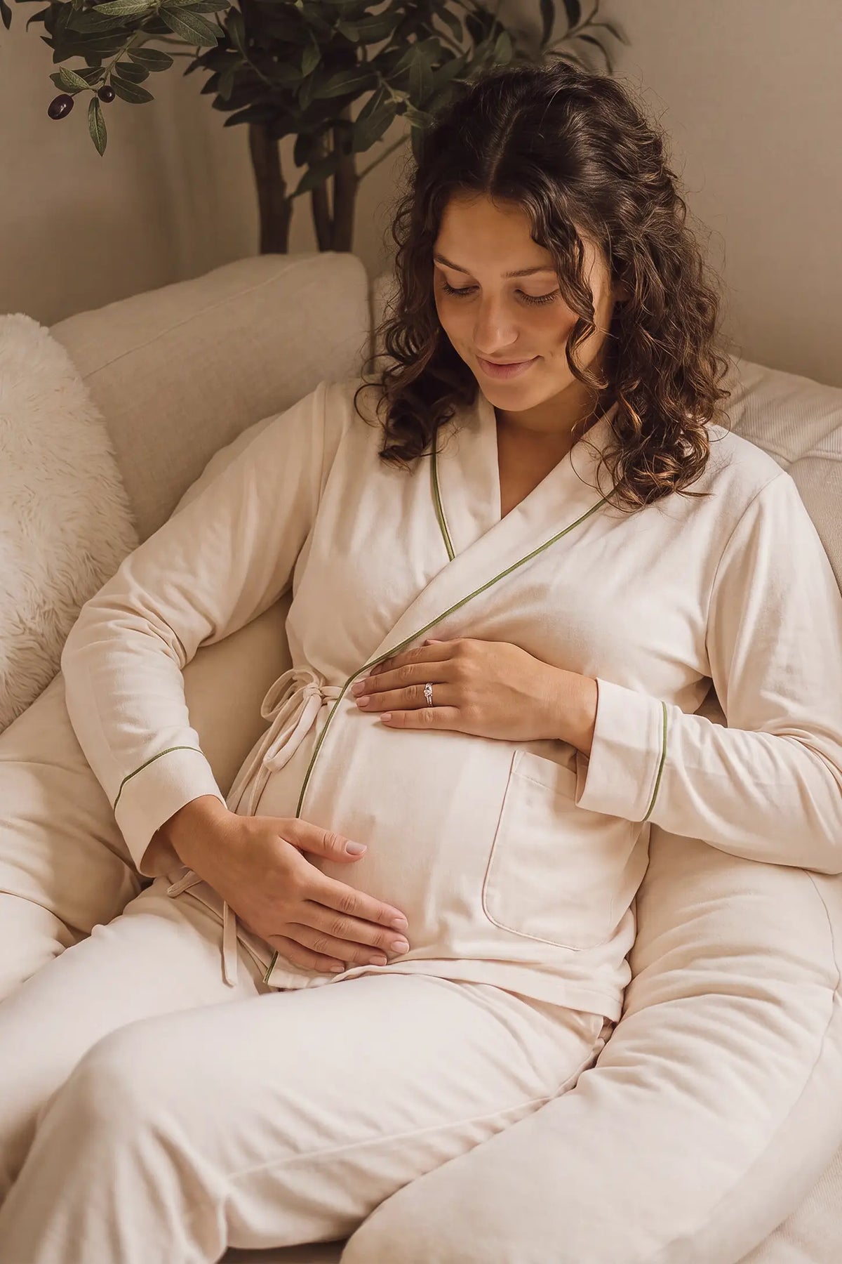 Cotton Wrap Front Long Sleeve Top Wide Leg Pants Maternity Sleepwear Cotton Wrap Front Long Sleeve Top Wide Leg Pants Maternity Sleepwear in Beige featuring built-in bust support, adjustable waist fit, and a relaxed silhouette on a pregnant model in a home setting.