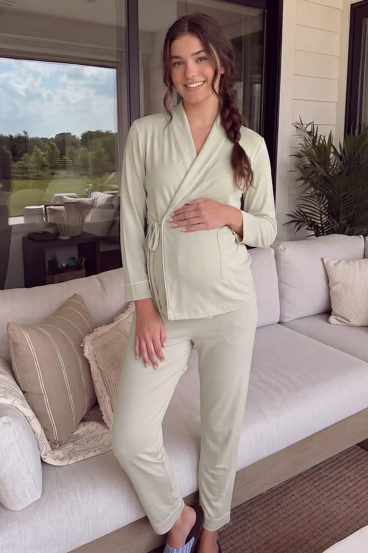 Cotton Wrap Front Long Sleeve Top Wide Leg Pants Maternity Sleepwear Cotton Wrap Front Long Sleeve Top Wide Leg Pants Maternity Sleepwear in Light Green featuring a comfortable wrap front top and relaxed wide-leg pants on a pregnant model in a cozy lifestyle setting.