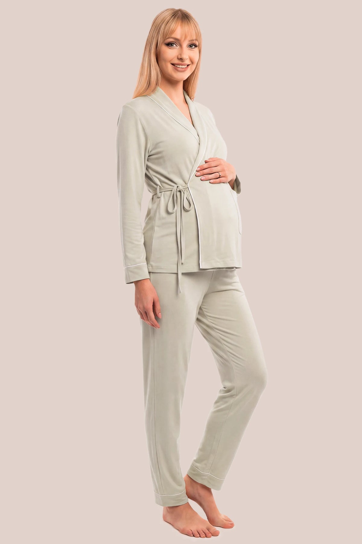 Cotton Wrap Front Long Sleeve Top Wide Leg Pants Maternity Sleepwear Cotton Wrap Front Long Sleeve Top Wide Leg Pants Maternity Sleepwear in Light Green featuring a relaxed silhouette, adjustable waist fit, wide-leg pants, and comfortable long sleeves on a pregnant model, side view.