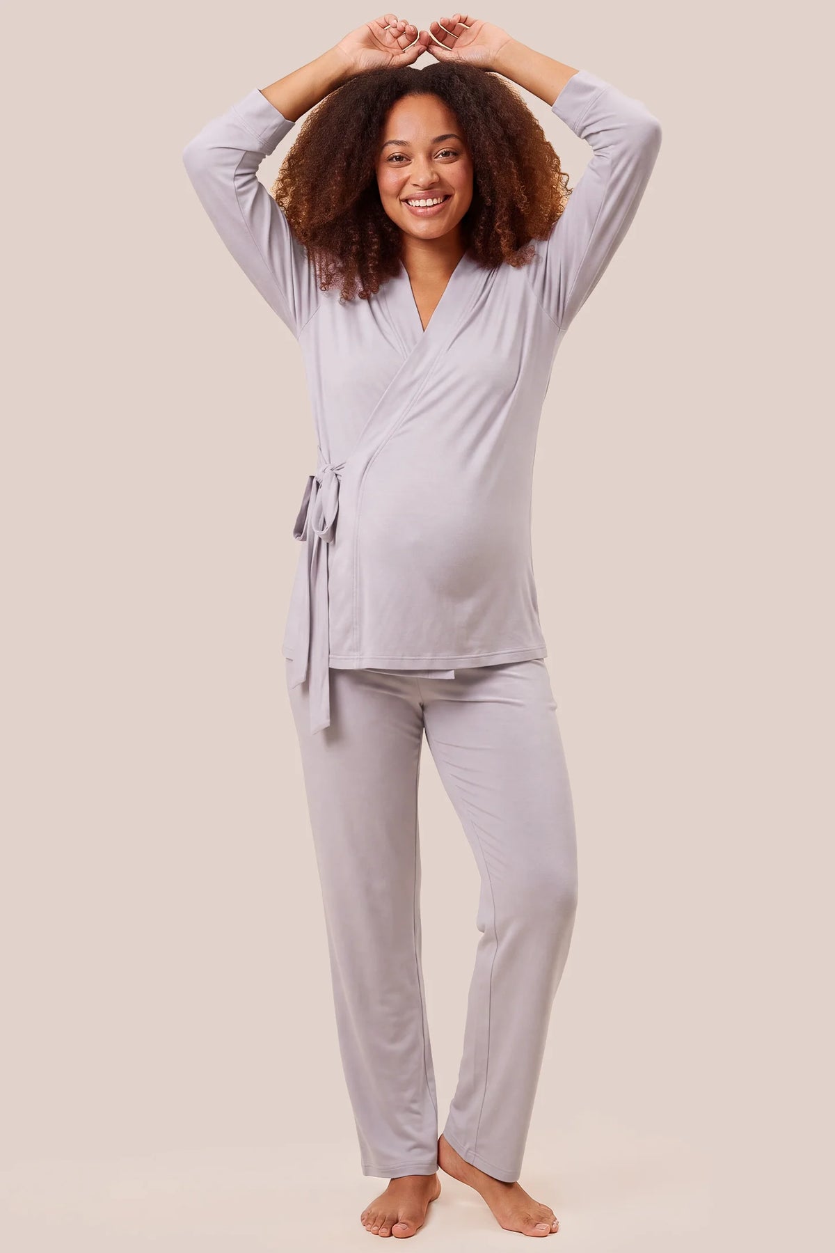 Cotton Wrap Front Long Sleeve Top Wide Leg Pants Maternity Sleepwear Cotton Wrap Front Long Sleeve Top Wide Leg Pants Maternity Sleepwear in Light Purple featuring a comfortable wrap front neckline, relaxed sleeve openings, built-in bust support, neatly folded hems, and an adjustable waist fit on a pregnant model, front view.