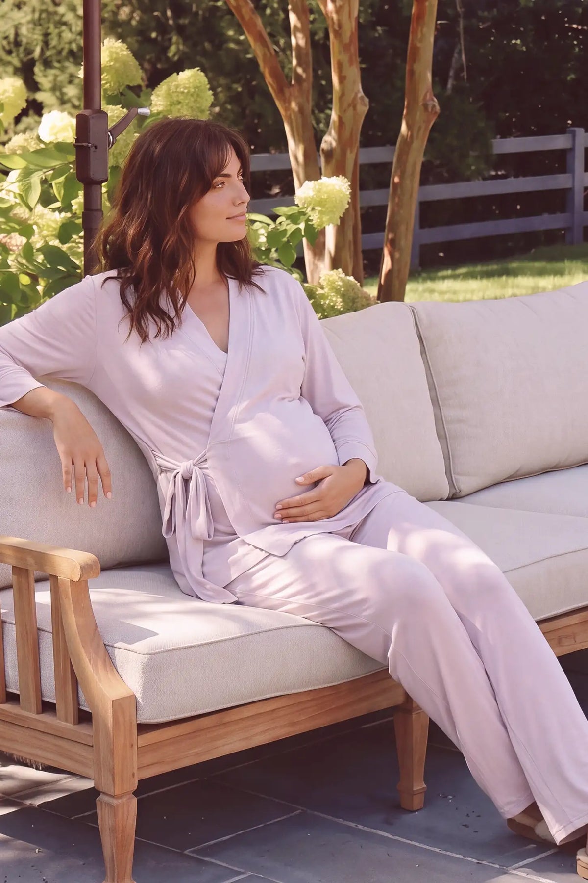 Cotton Wrap Front Long Sleeve Top Wide Leg Pants Maternity Sleepwear Cotton Wrap Front Long Sleeve Top Wide Leg Pants Maternity Sleepwear in Light Purple featuring a comfortable wrap front top and relaxed wide-leg pants on a pregnant model in a cozy lifestyle setting.