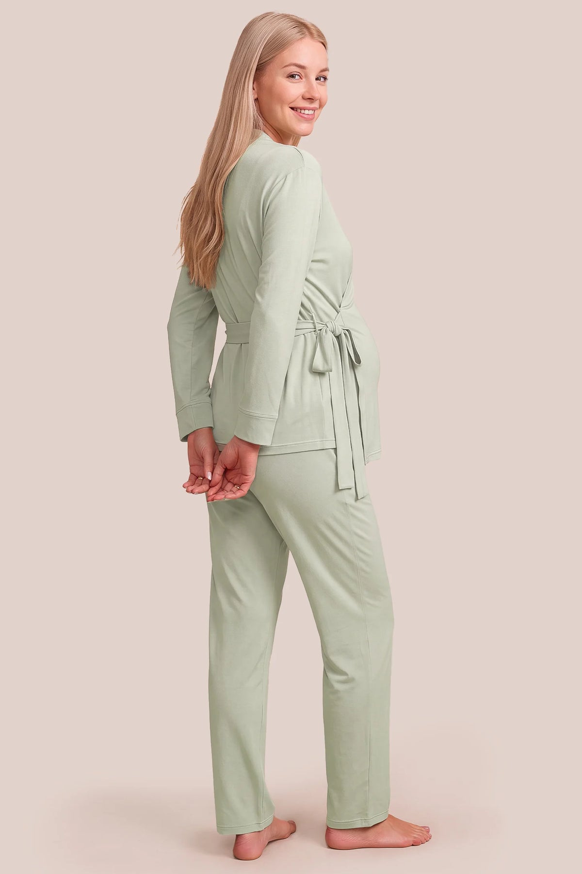 Cotton Wrap Front Long Sleeve Top Wide Leg Pants Maternity Sleepwear Cotton Wrap Front Long Sleeve Top Wide Leg Pants Maternity Sleepwear in Pale Olive featuring a relaxed back design, long sleeves, wide-leg pants, and a comfortable maternity-friendly silhouette on a pregnant model, back view.