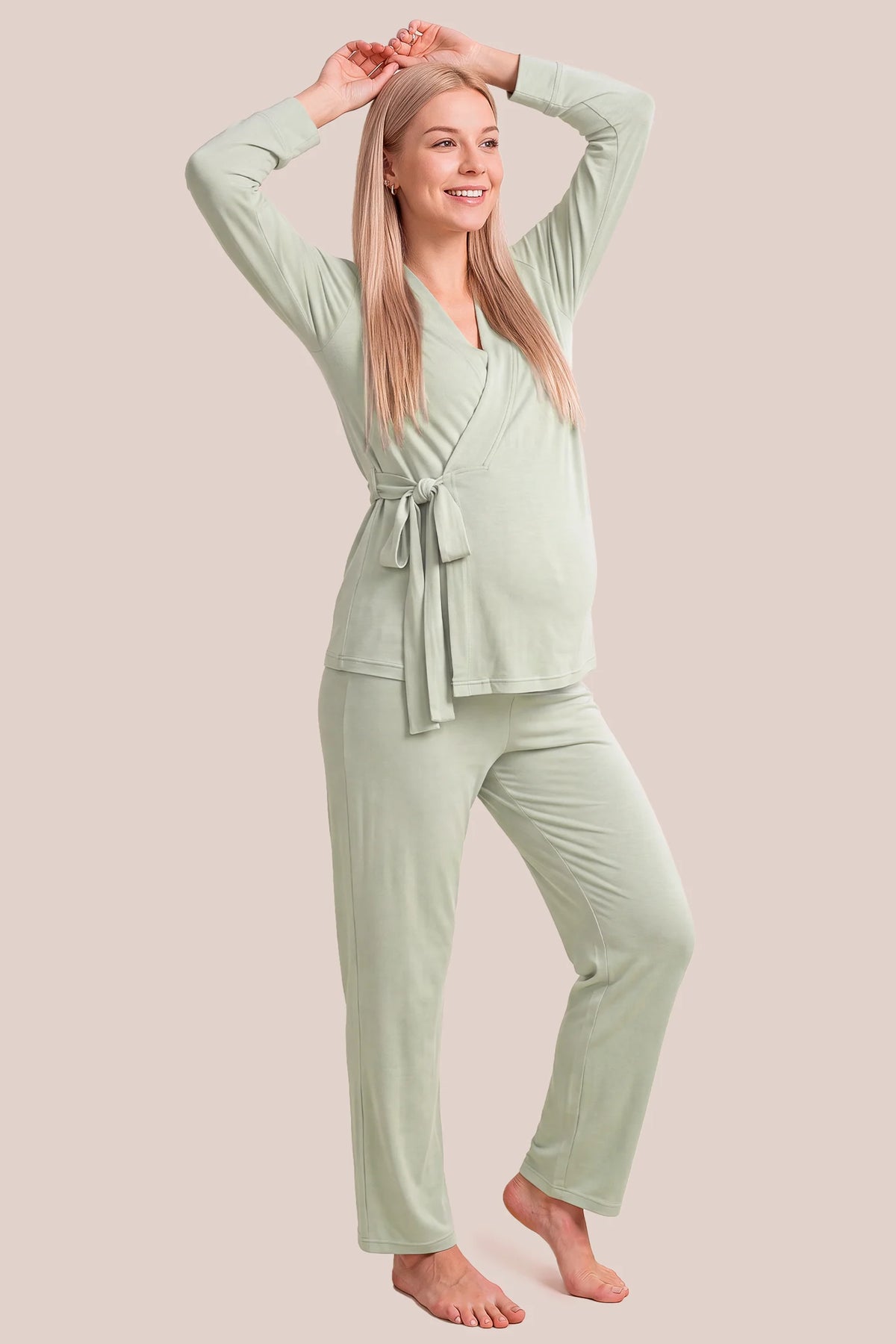 Cotton Wrap Front Long Sleeve Top Wide Leg Pants Maternity Sleepwear Cotton Wrap Front Long Sleeve Top Wide Leg Pants Maternity Sleepwear in Pale Olive featuring a comfortable wrap front neckline, relaxed sleeve openings, built-in bust support, neatly folded hems, and an adjustable waist fit on a pregnant model, front view.
