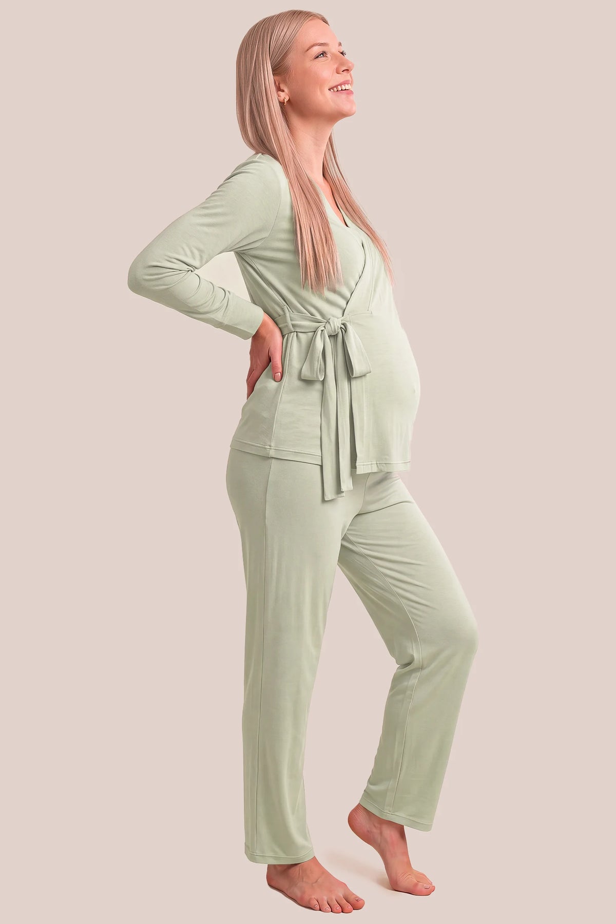 Cotton Wrap Front Long Sleeve Top Wide Leg Pants Maternity Sleepwear Cotton Wrap Front Long Sleeve Top Wide Leg Pants Maternity Sleepwear in Pale Olive featuring a relaxed silhouette, adjustable waist fit, wide-leg pants, and comfortable long sleeves on a pregnant model, side view.