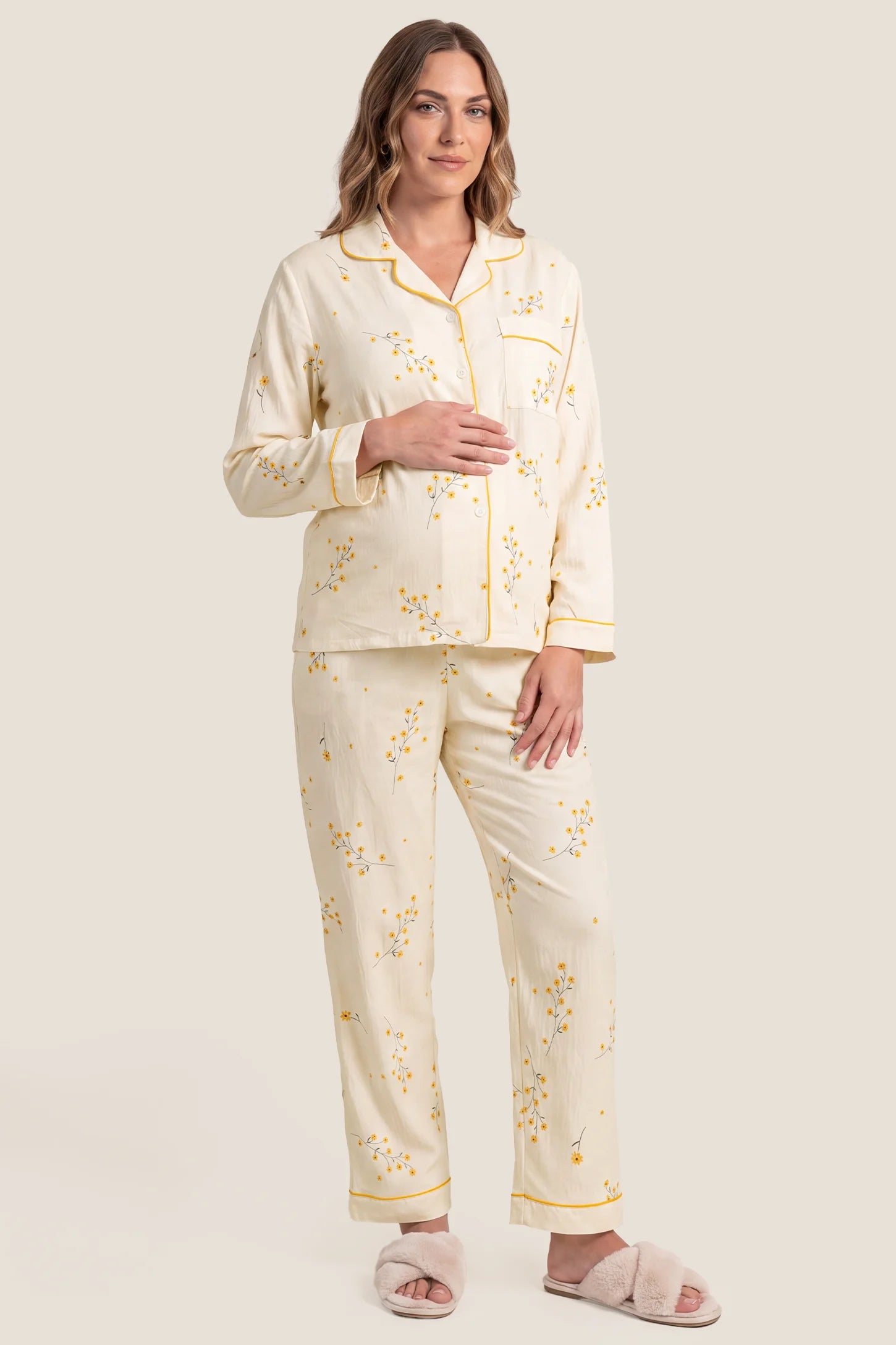 Cozy Floral Cotton Maternity Pajama Set Cozy Floral Cotton Maternity Pajama Set in Yellow Daisy featuring a button-front long sleeve shirt and matching long pants in a relaxed fit on a pregnant model, studio full-body front view.