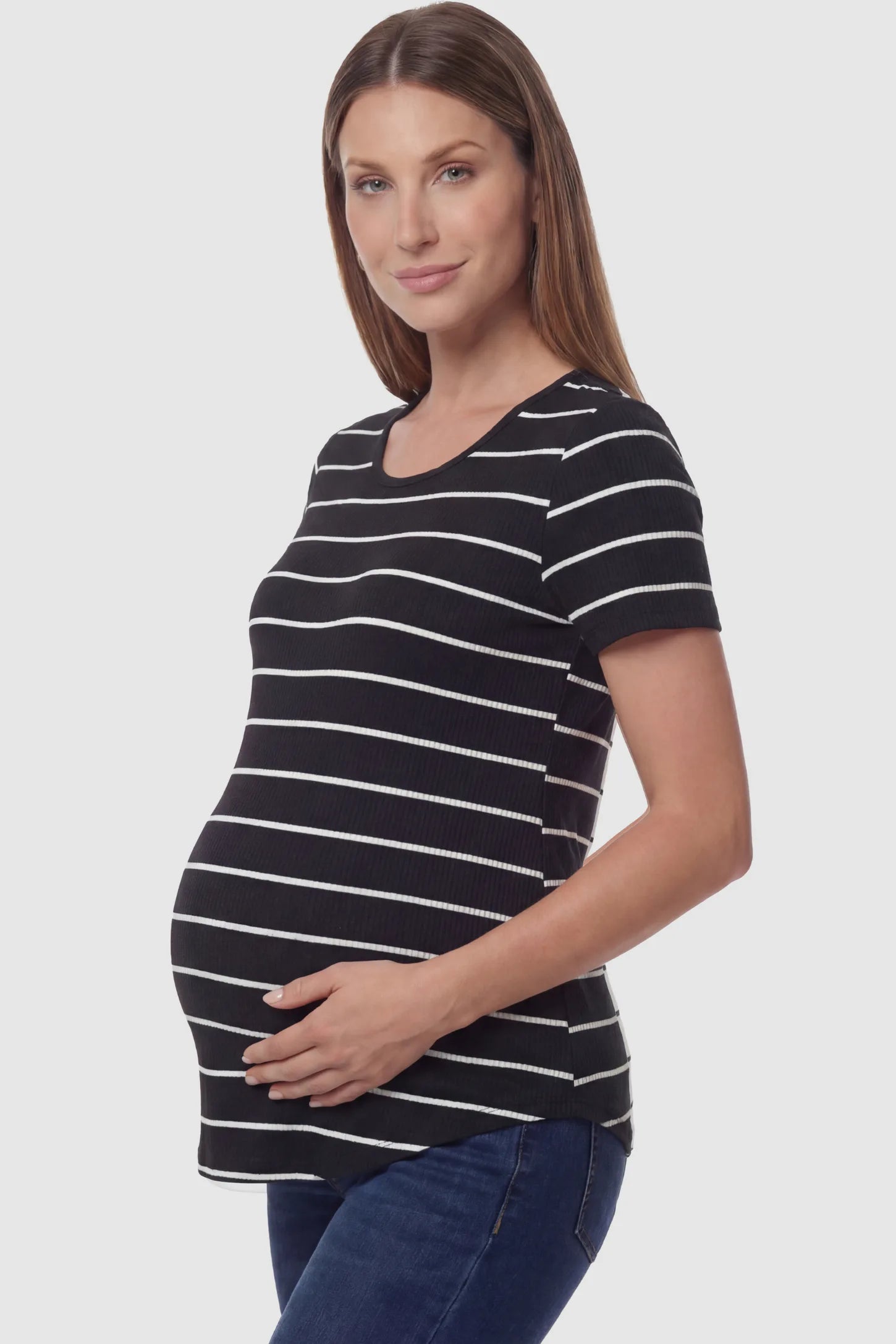 Striped crew neck short sleeve maternity top in black and white shown in side view on a pregnant model