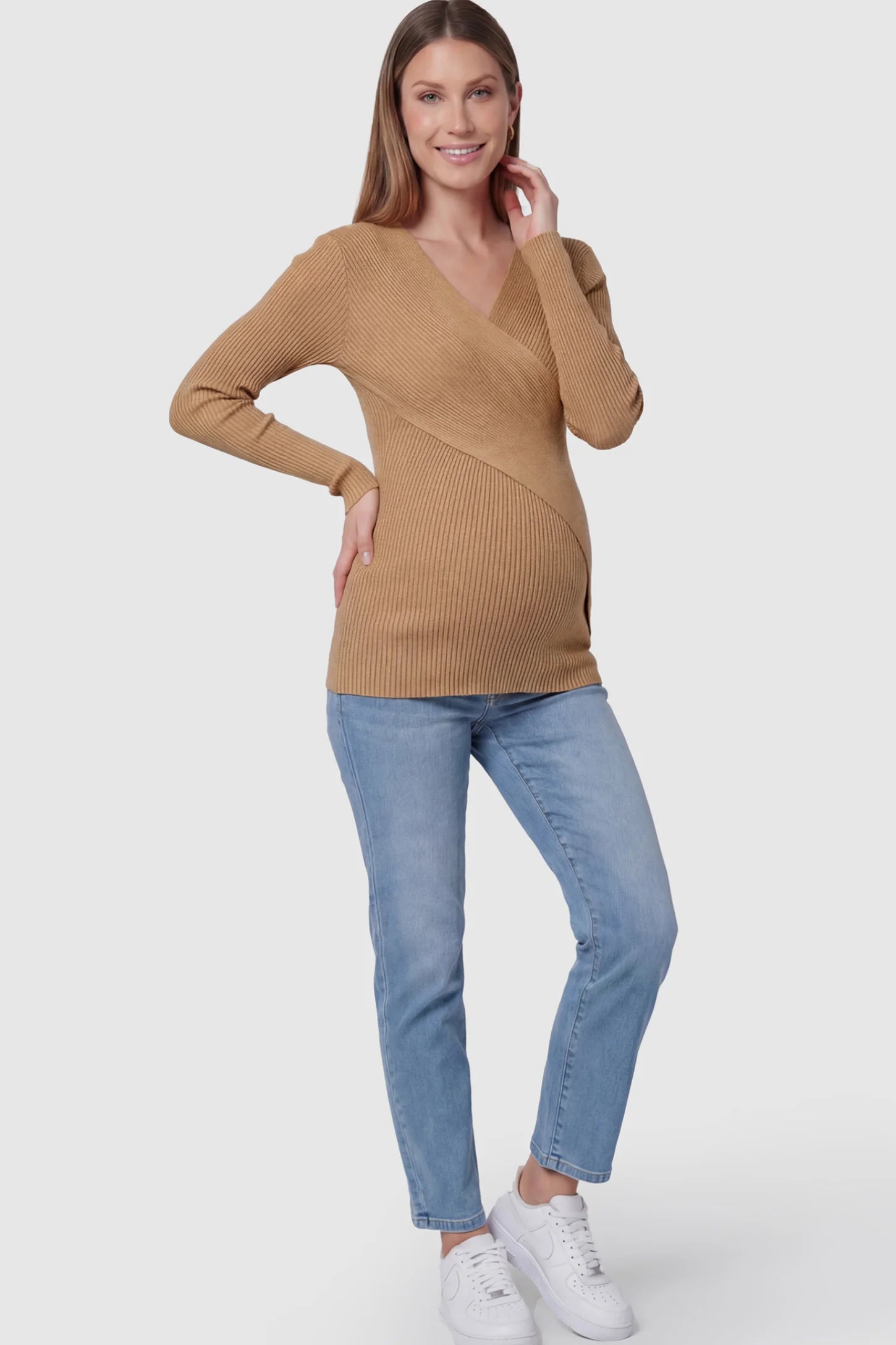 Cross-Over Ribbed Knit Maternity & Nursing Top Cross-Over Ribbed Knit Maternity & Nursing Top in Coffee featuring a wrap neckline and textured finish on a pregnant model, full body shot.