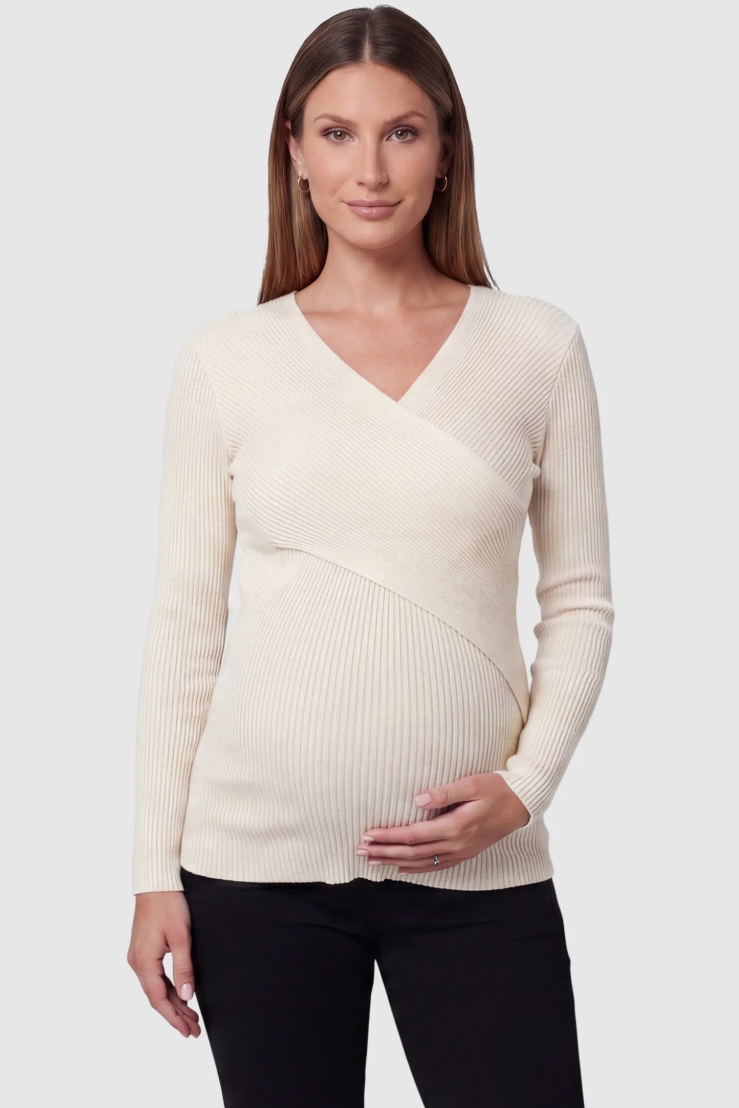 Cross-Over Ribbed Knit Maternity & Nursing Top Cross-Over Ribbed Knit Maternity & Nursing Top in Apricot featuring a wrap neckline and textured finish on a pregnant model, front view.