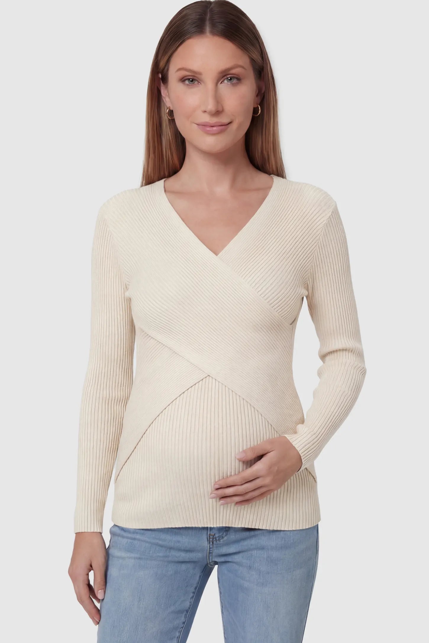 Cross-Over Ribbed Knit Maternity & Nursing Top Cross-Over Ribbed Knit Maternity & Nursing Top in Apricot featuring a wrap neckline and textured finish on a pregnant model, front view.
