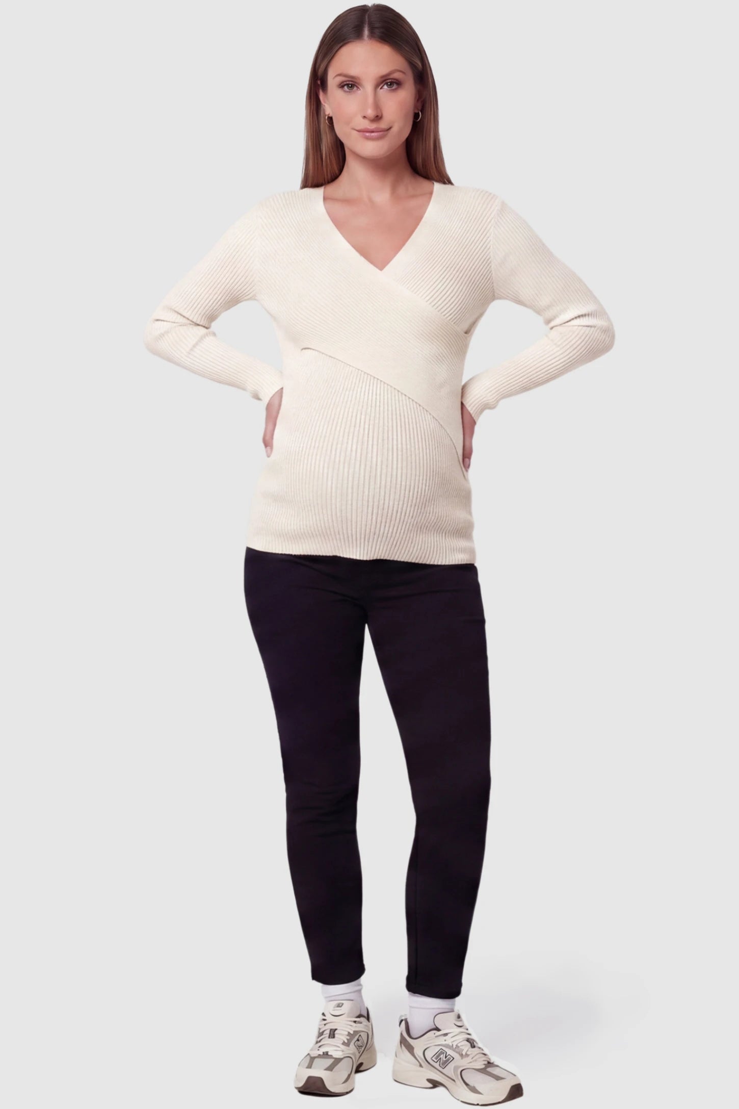 Cross-Over Ribbed Knit Maternity & Nursing Top Cross-Over Ribbed Knit Maternity & Nursing Top in Apricot featuring a wrap neckline and textured finish on a pregnant model, full body view.