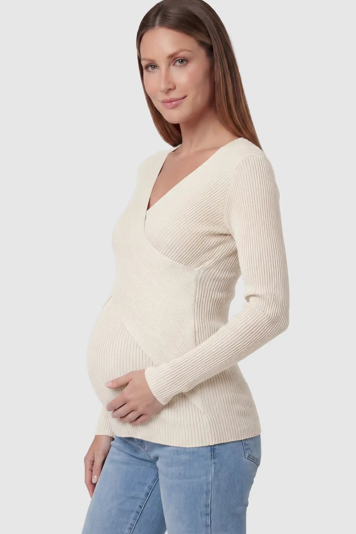 Cross-Over Ribbed Knit Maternity & Nursing Top Cross-Over Ribbed Knit Maternity & Nursing Top in Apricot featuring a wrap neckline and textured finish on a pregnant model, side view.