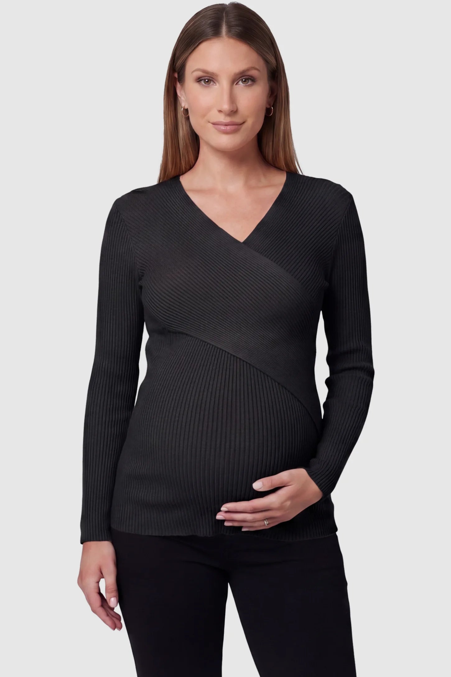 Cross-Over Ribbed Knit Maternity & Nursing Top Cross-Over Ribbed Knit Maternity & Nursing Top in Black featuring a wrap neckline and textured finish on a pregnant model, front view.