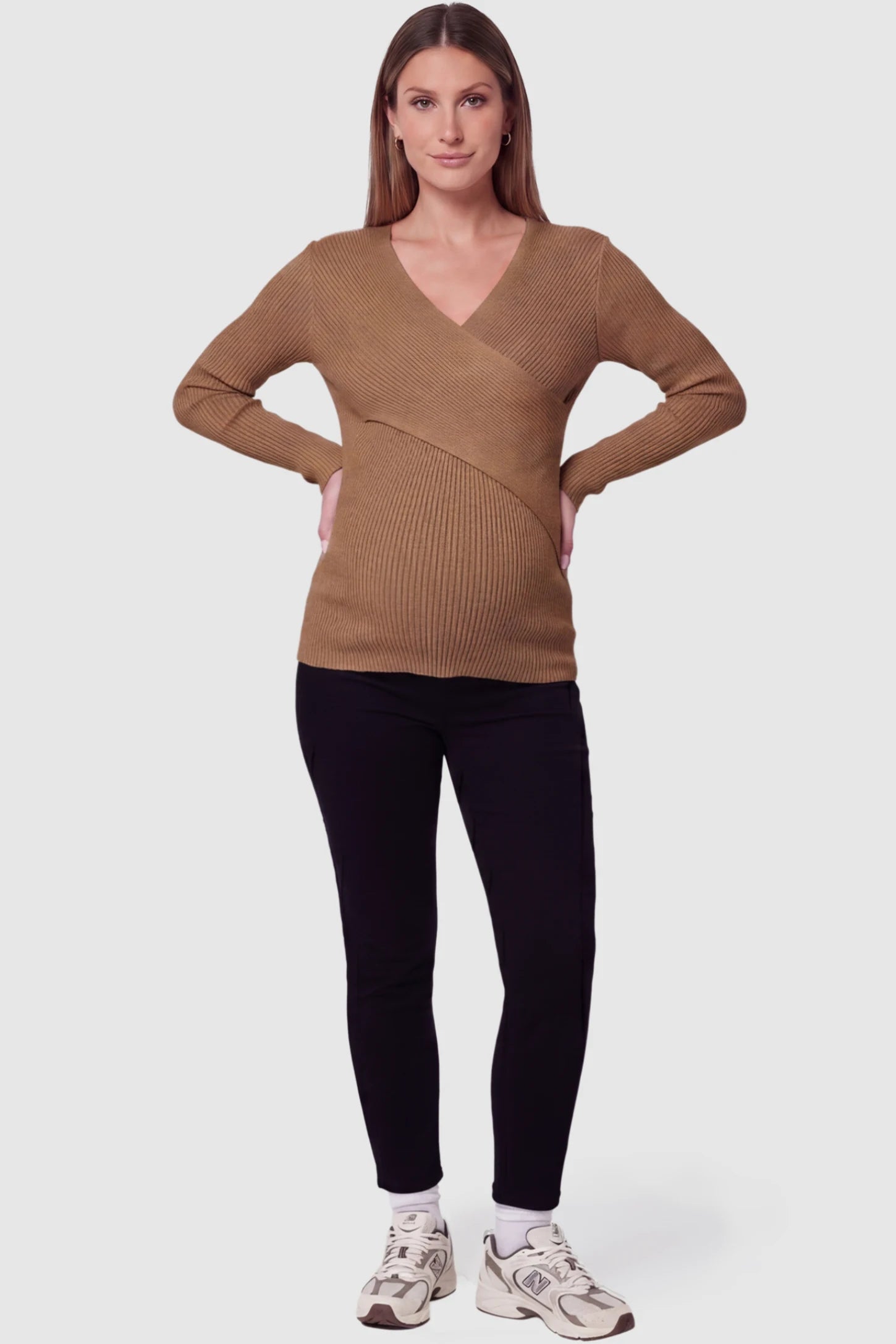 Cross-Over Ribbed Knit Maternity & Nursing Top Cross-Over Ribbed Knit Maternity & Nursing Top in Coffee featuring a wrap neckline and textured finish on a pregnant model, full body view.
