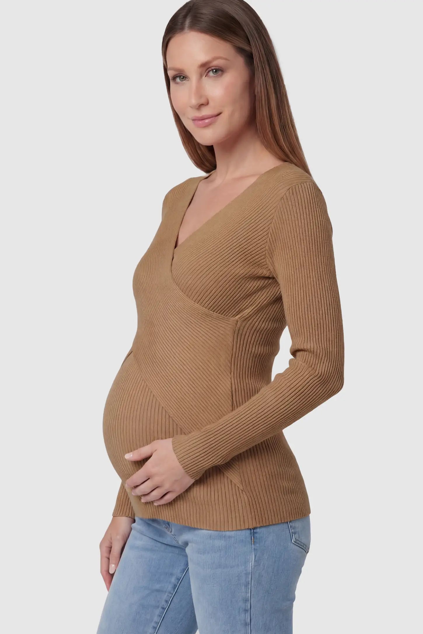 Cross-Over Ribbed Knit Maternity & Nursing Top Cross-Over Ribbed Knit Maternity & Nursing Top in Coffee featuring a wrap neckline and textured finish on a pregnant model, side view.