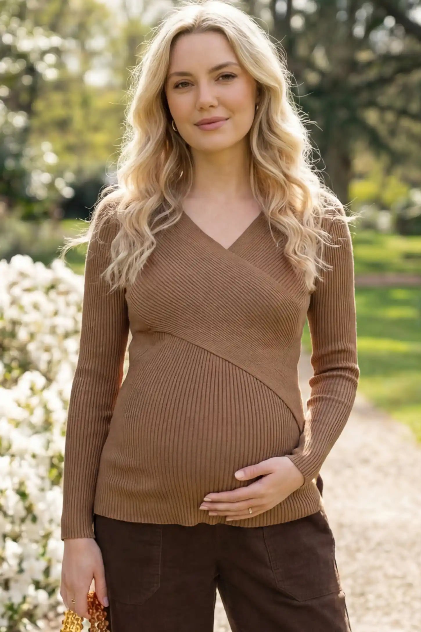 Cross-Over Ribbed Knit Maternity & Nursing Top Cross-Over Ribbed Knit Maternity & Nursing Top in Coffee featuring a wrap neckline and textured finish on a pregnant woman, front view.