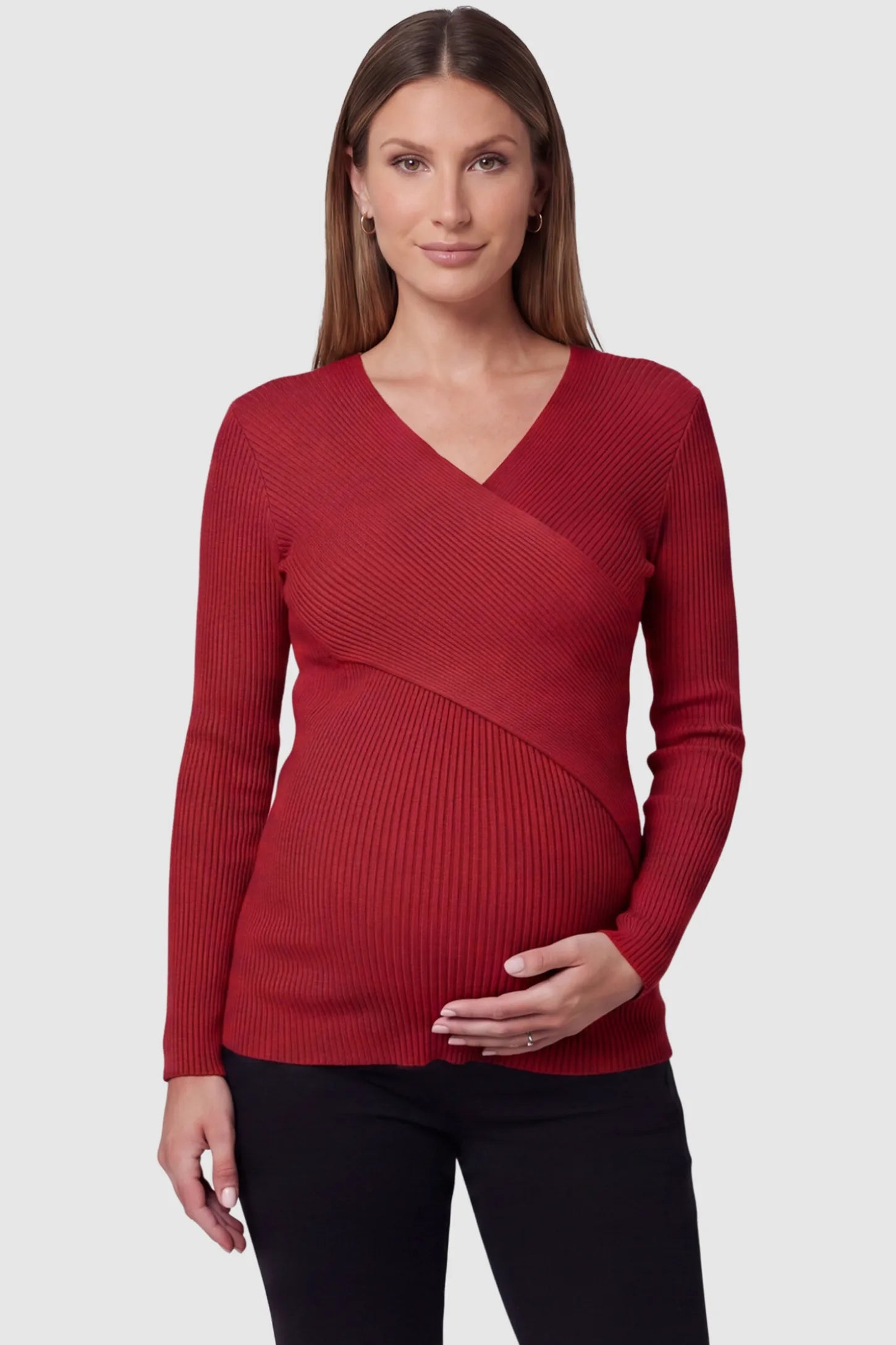 Cross-Over Ribbed Knit Maternity & Nursing Top Cross-Over Ribbed Knit Maternity & Nursing Top in Red featuring a wrap neckline and textured finish on a pregnant model, front view.