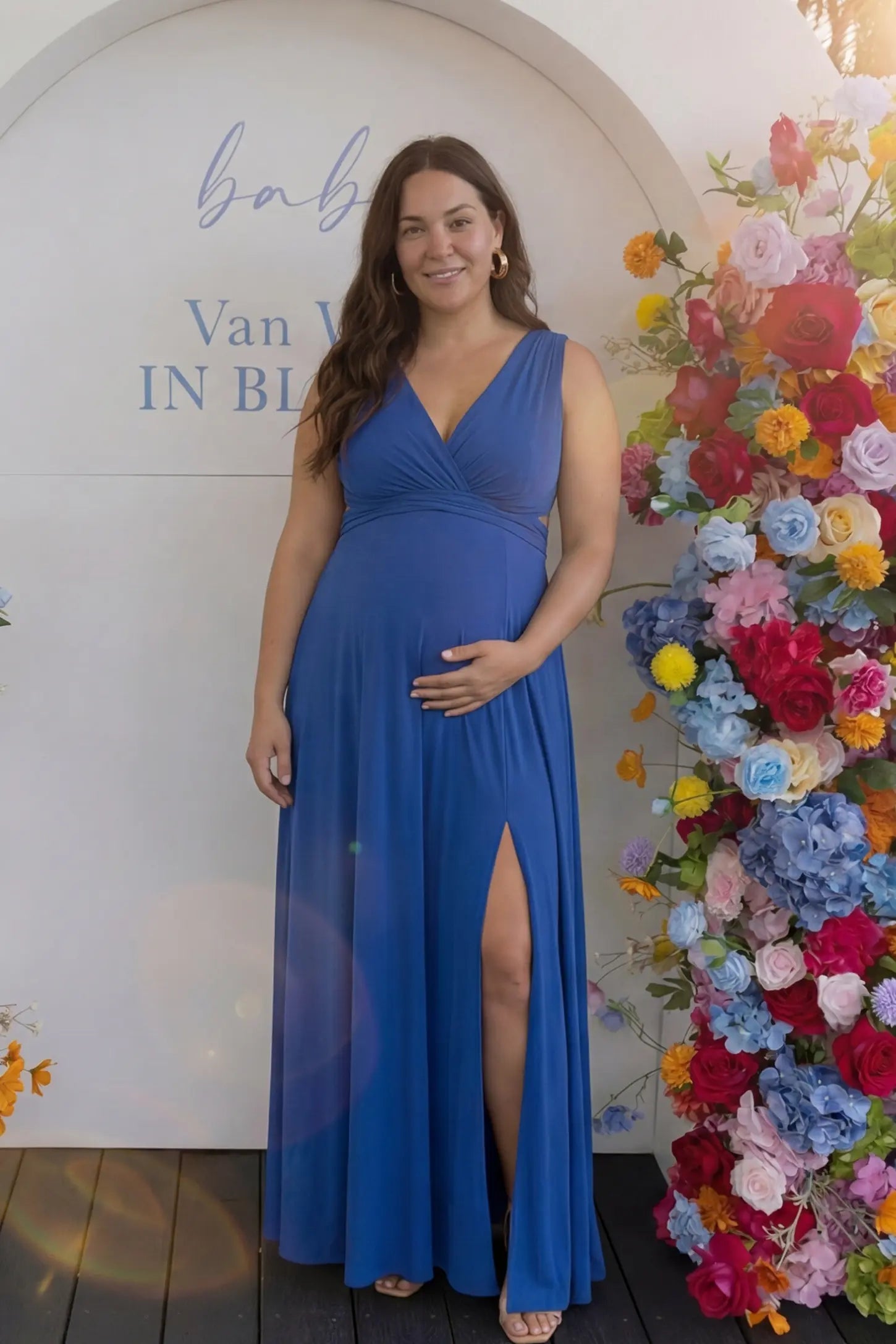 V-Neck Cross-Back Maxi Maternity Dress in Blue featuring a bold thigh-high slit on a pregnant model in a front view.