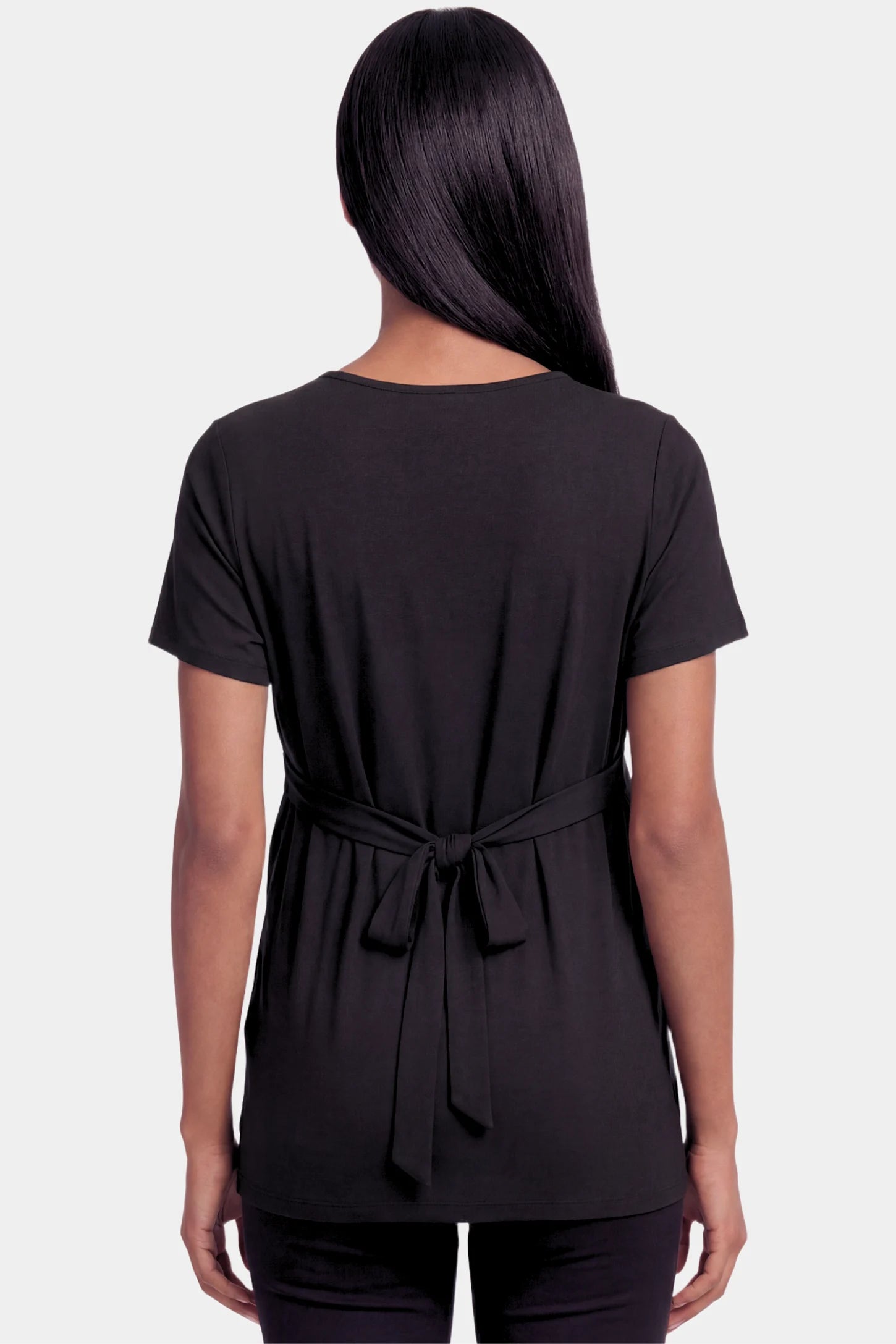 Crossover Short Sleeve Maternity & Nursing Top Crossover Short Sleeve Maternity & Nursing Top in black featuring a crossover V-neck and empire waist on a pregnant model.