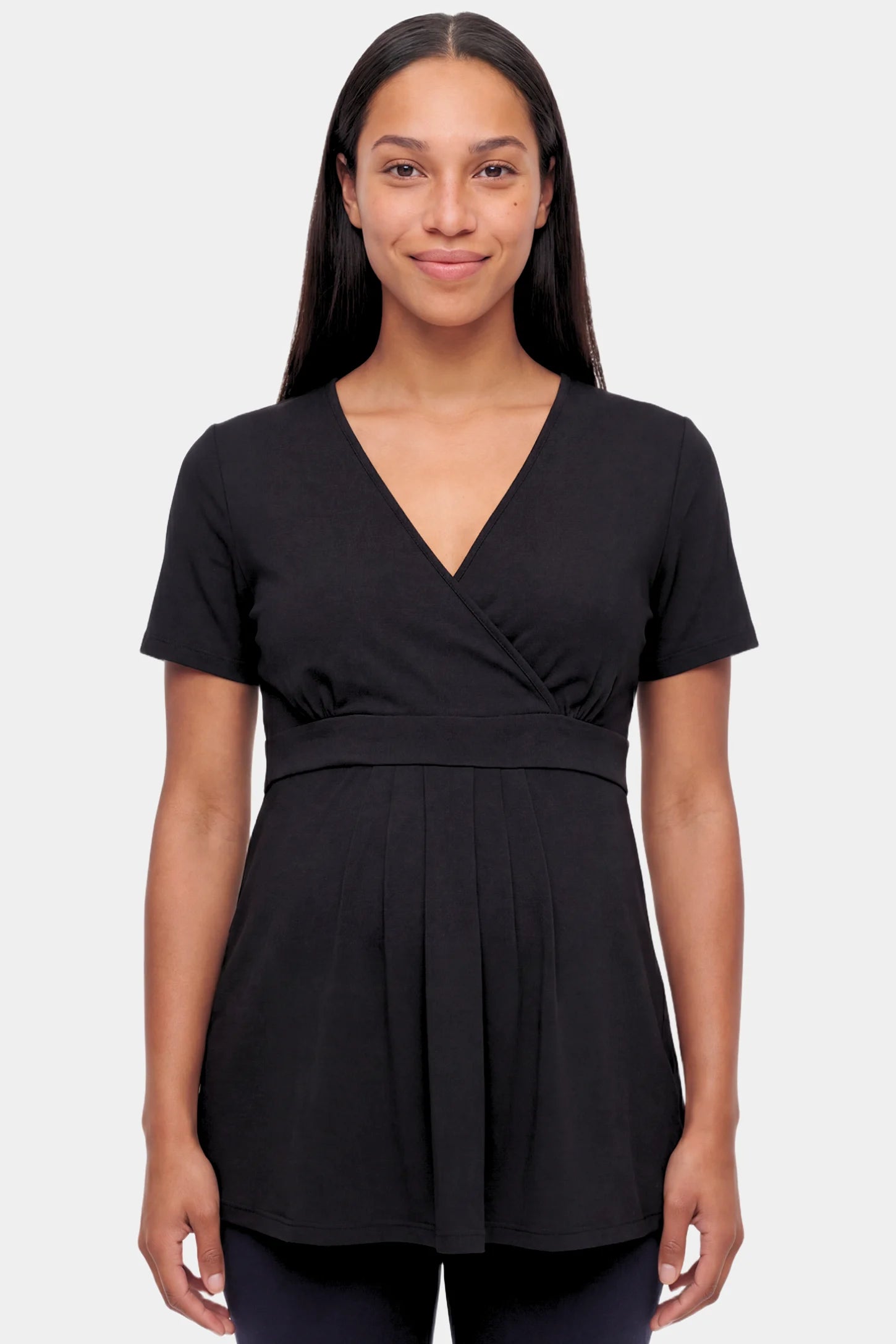 Crossover Short Sleeve Maternity & Nursing Top Crossover Short Sleeve Maternity & Nursing Top in black featuring a crossover V-neck and empire waist on a pregnant model.