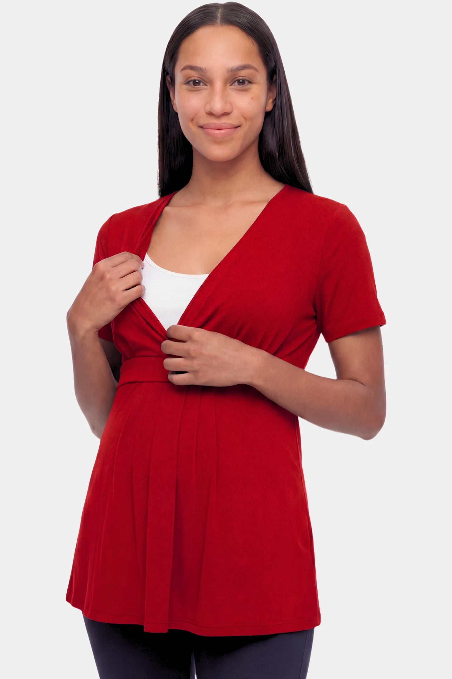 Crossover Short Sleeve Maternity & Nursing Top Crossover Short Sleeve Maternity & Nursing Top in burgundy featuring a crossover V-neck and empire waist on a pregnant model.
