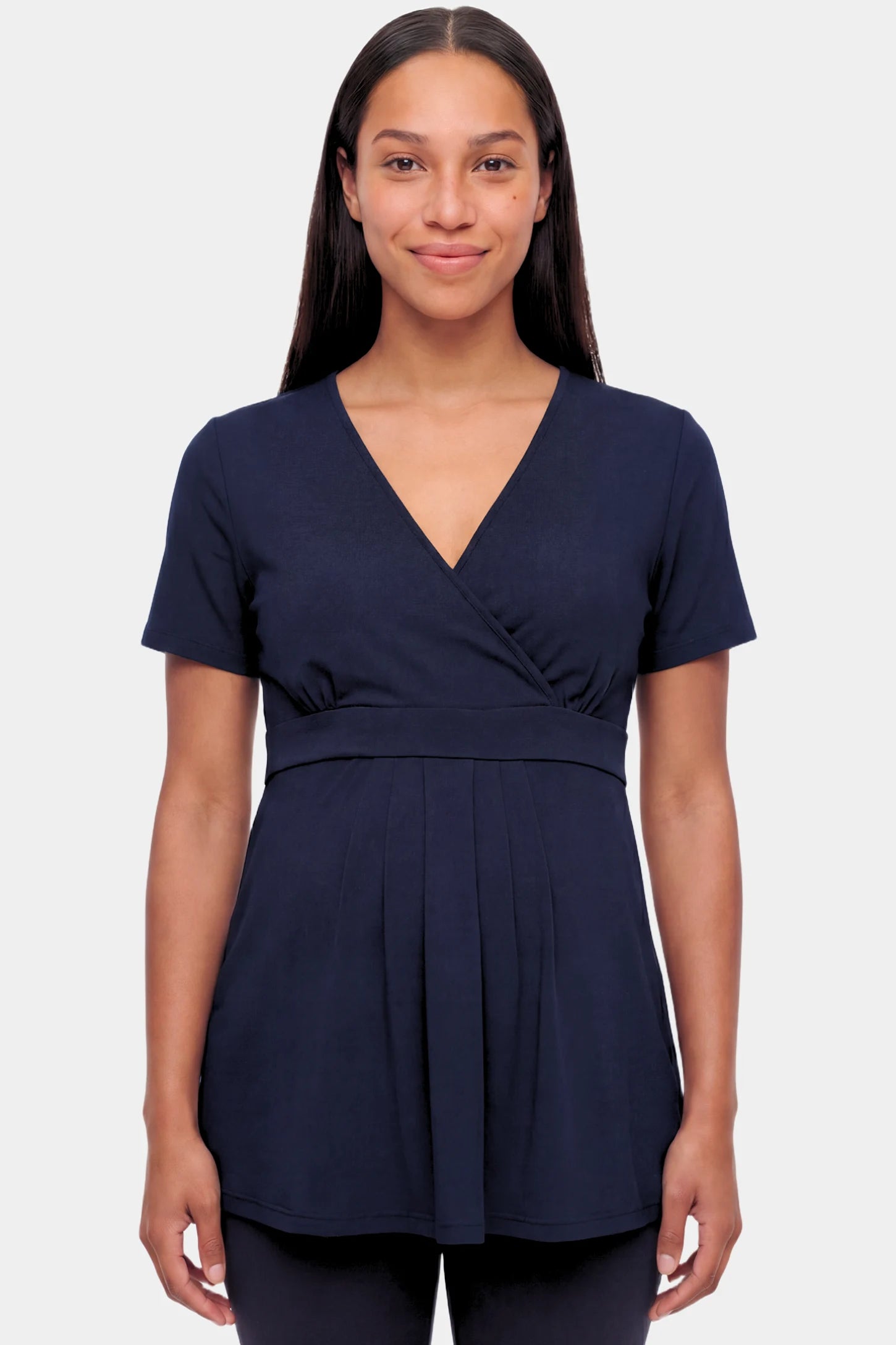 Crossover Short Sleeve Maternity & Nursing Top Crossover Short Sleeve Maternity & Nursing Top in dark blue featuring a crossover V-neck and empire waist on a pregnant model.