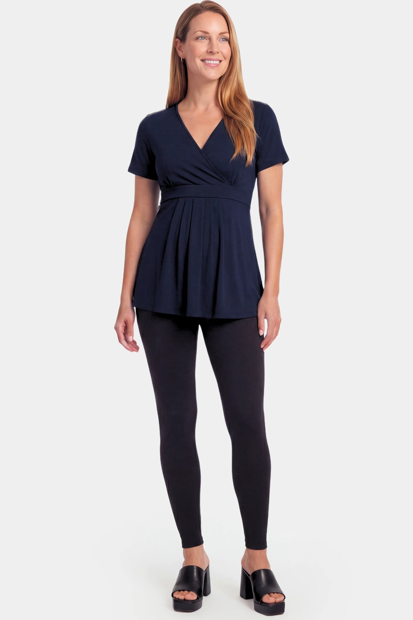 Crossover Short Sleeve Maternity & Nursing Top Crossover Short Sleeve Maternity & Nursing Top in dark blue featuring a crossover V-neck and empire waist on a non pregnant model.