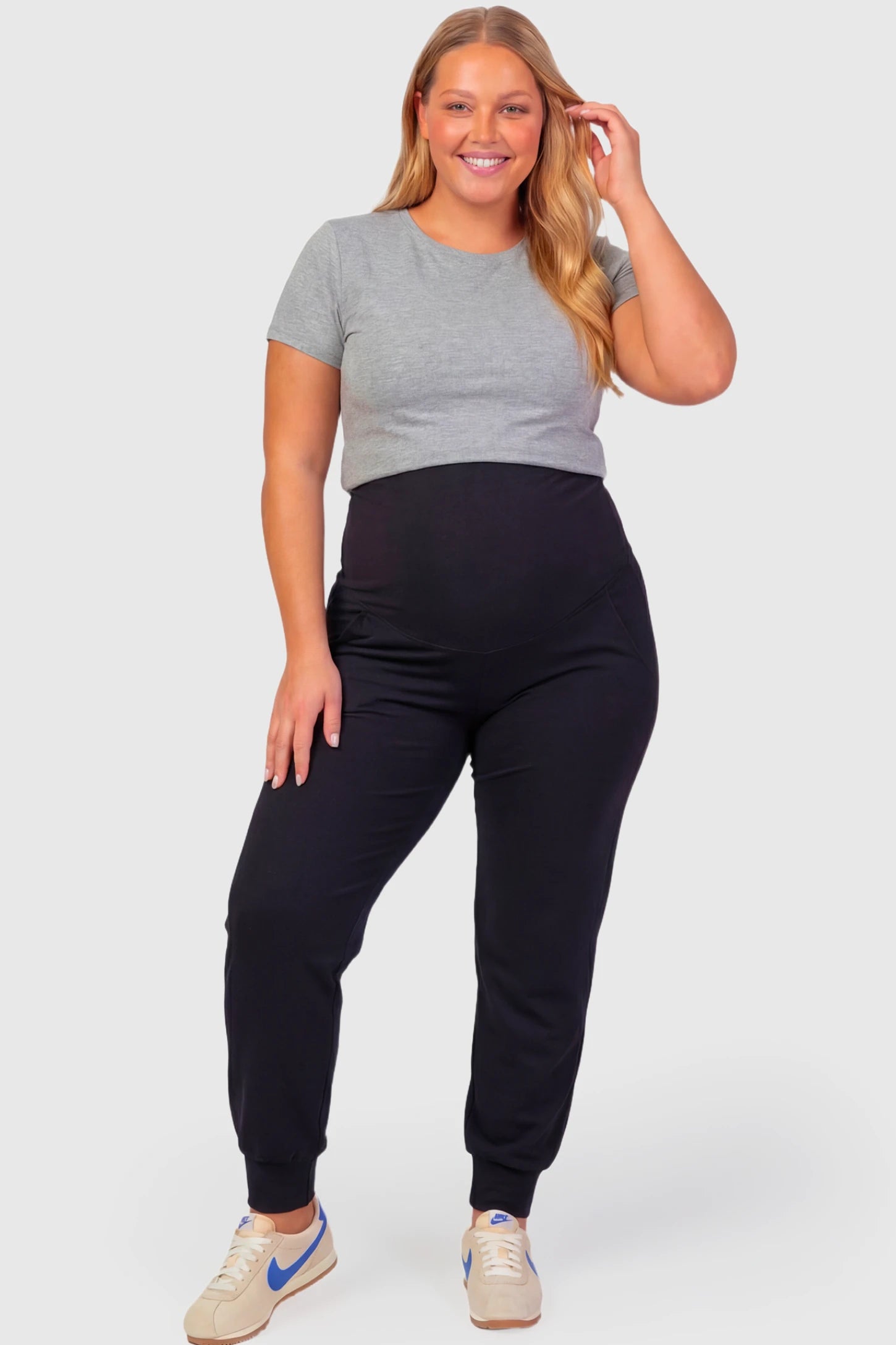 High-Rise Cuffed Maternity Joggers High-Rise Cuffed Maternity Joggers in black featuring over-the-belly support and ribbed cuff hem on plus size pregnant model.