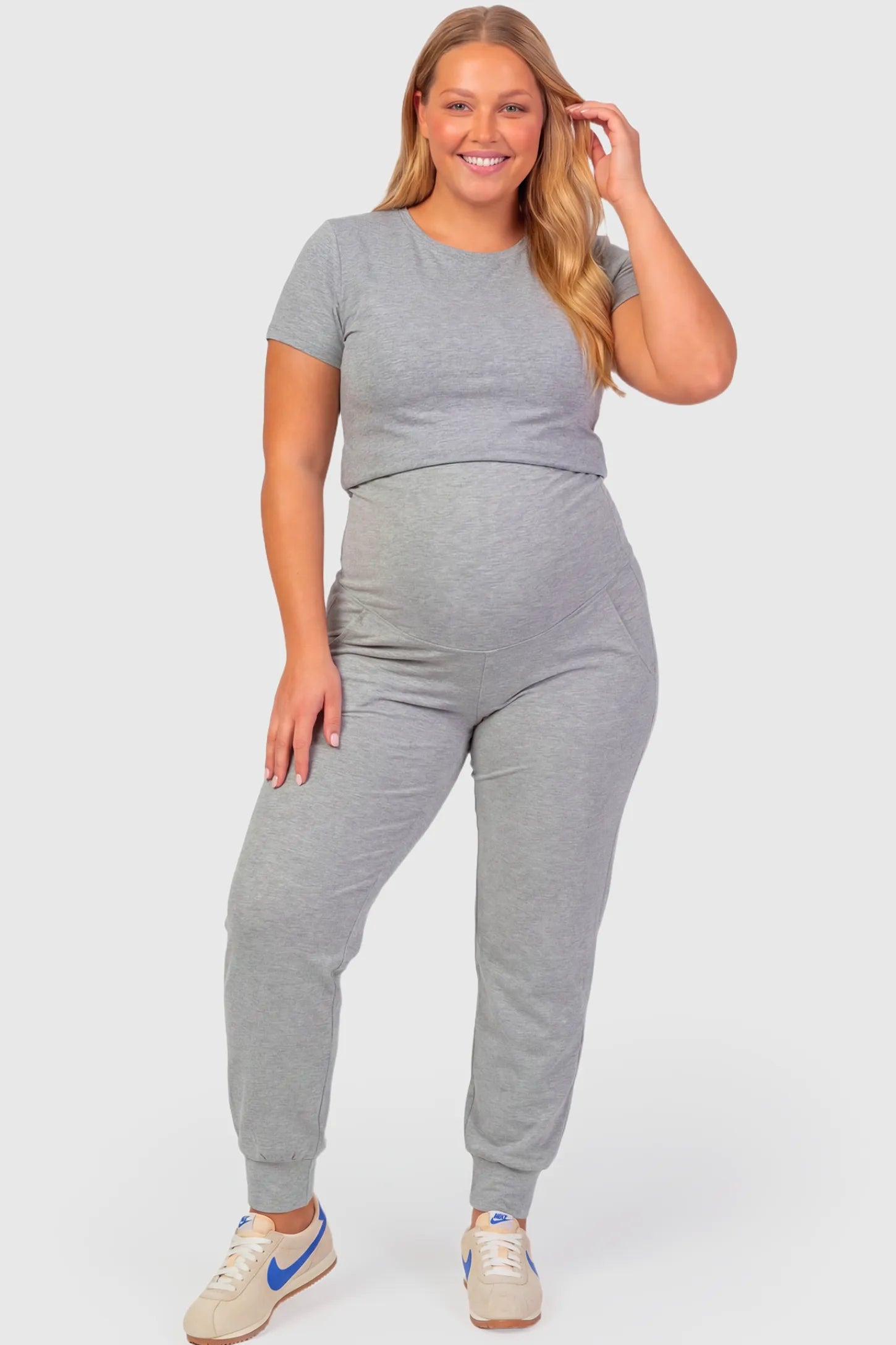 High-Rise Cuffed Maternity Joggers High-Rise Cuffed Maternity Joggers in gray featuring over-the-belly support and ribbed cuff hem on plus size pregnant model.