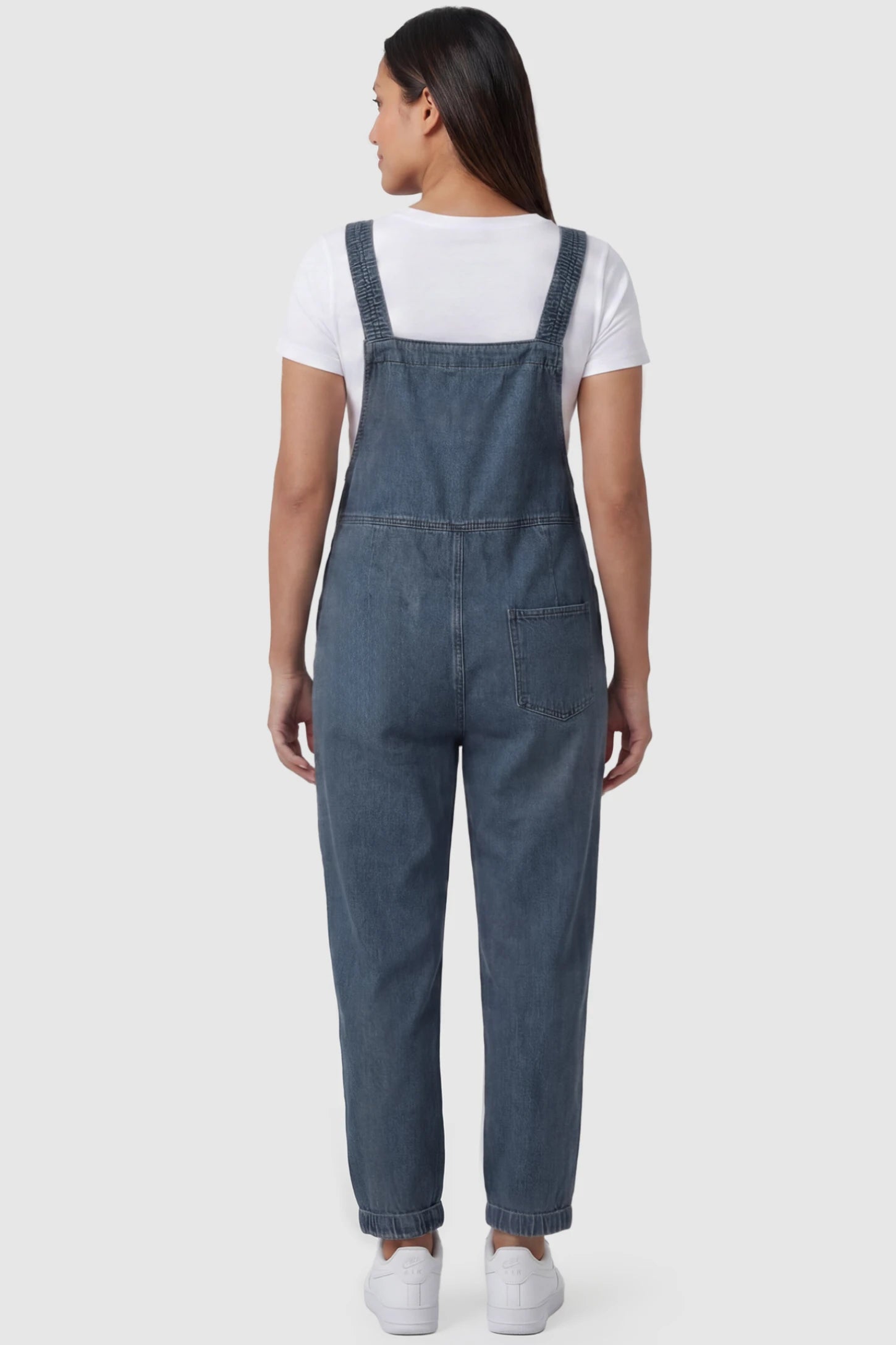 Wide Leg Denim Maternity Overalls Wide Leg Denim Maternity Overalls in blue with adjustable straps and relaxed fit on pregnant model back view.