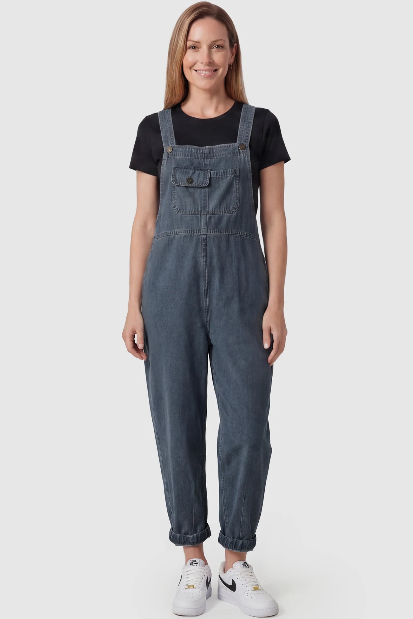 Wide Leg Denim Maternity Overalls Wide Leg Denim Maternity Overalls in blue with adjustable straps and relaxed fit on postpartum model front view.