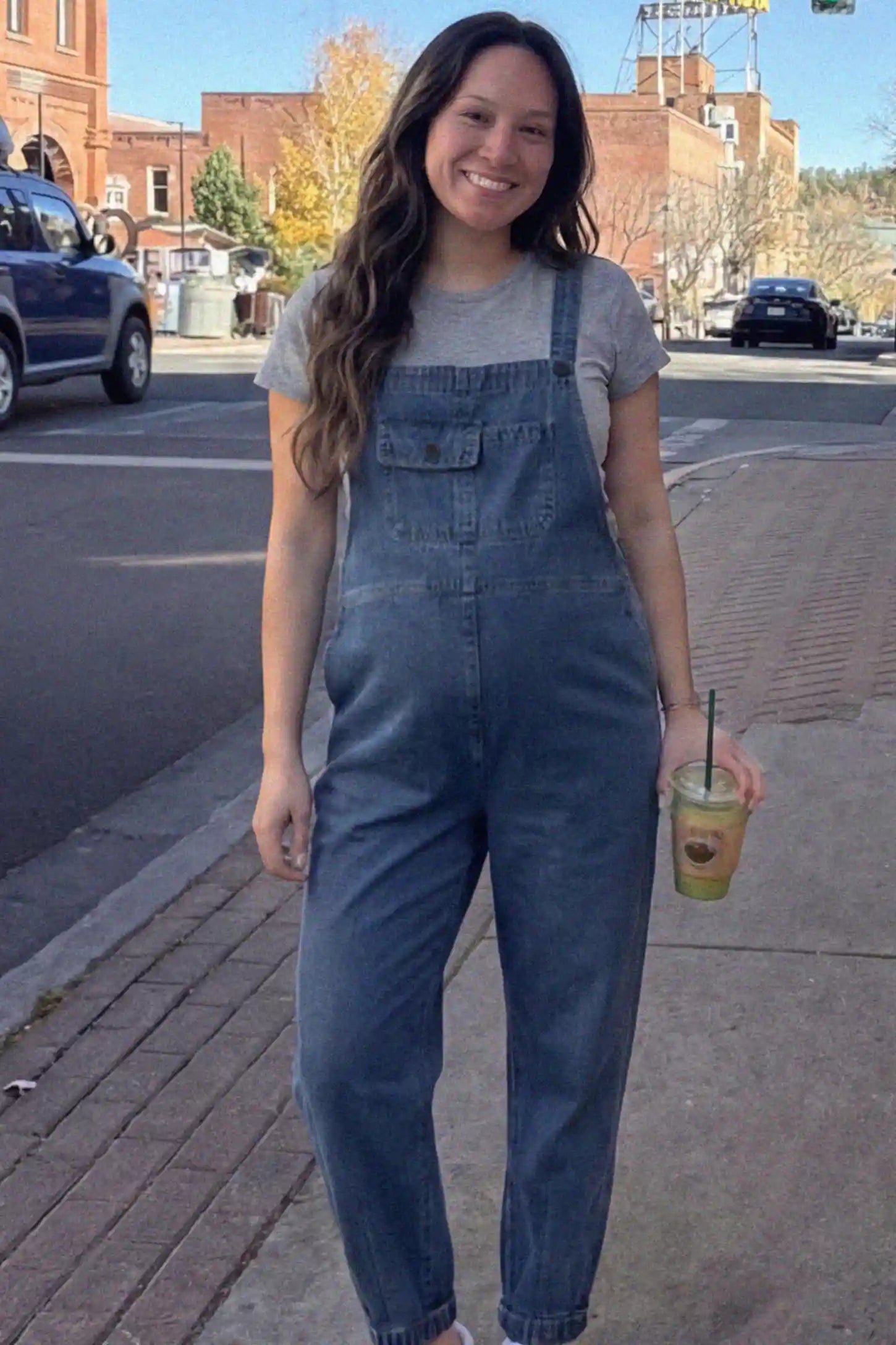 Wide Leg Denim Maternity Overalls Wide Leg Denim Maternity Overalls in blue with adjustable straps and relaxed fit on pregnant woman front view.