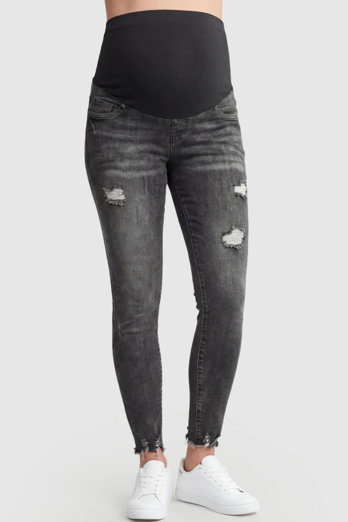 Frayed hem distressed cropped slim-fit maternity jeans in black with stretch belly panel, front view on pregnant model