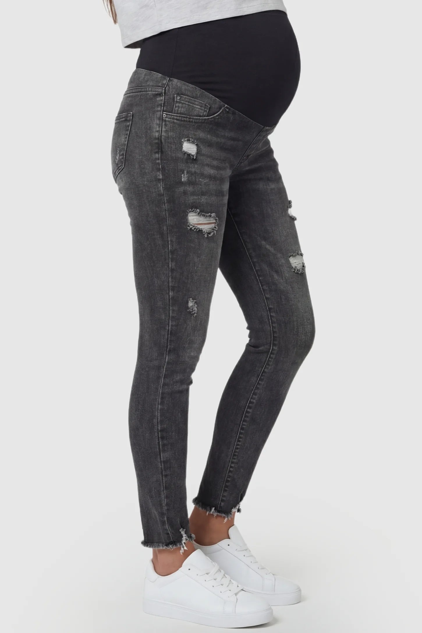 Frayed Hem Distressed Cropped Slim-Fit Maternity Jeans Frayed hem distressed cropped slim-fit maternity jeans in black with slim-fit silhouette, side view on pregnant model