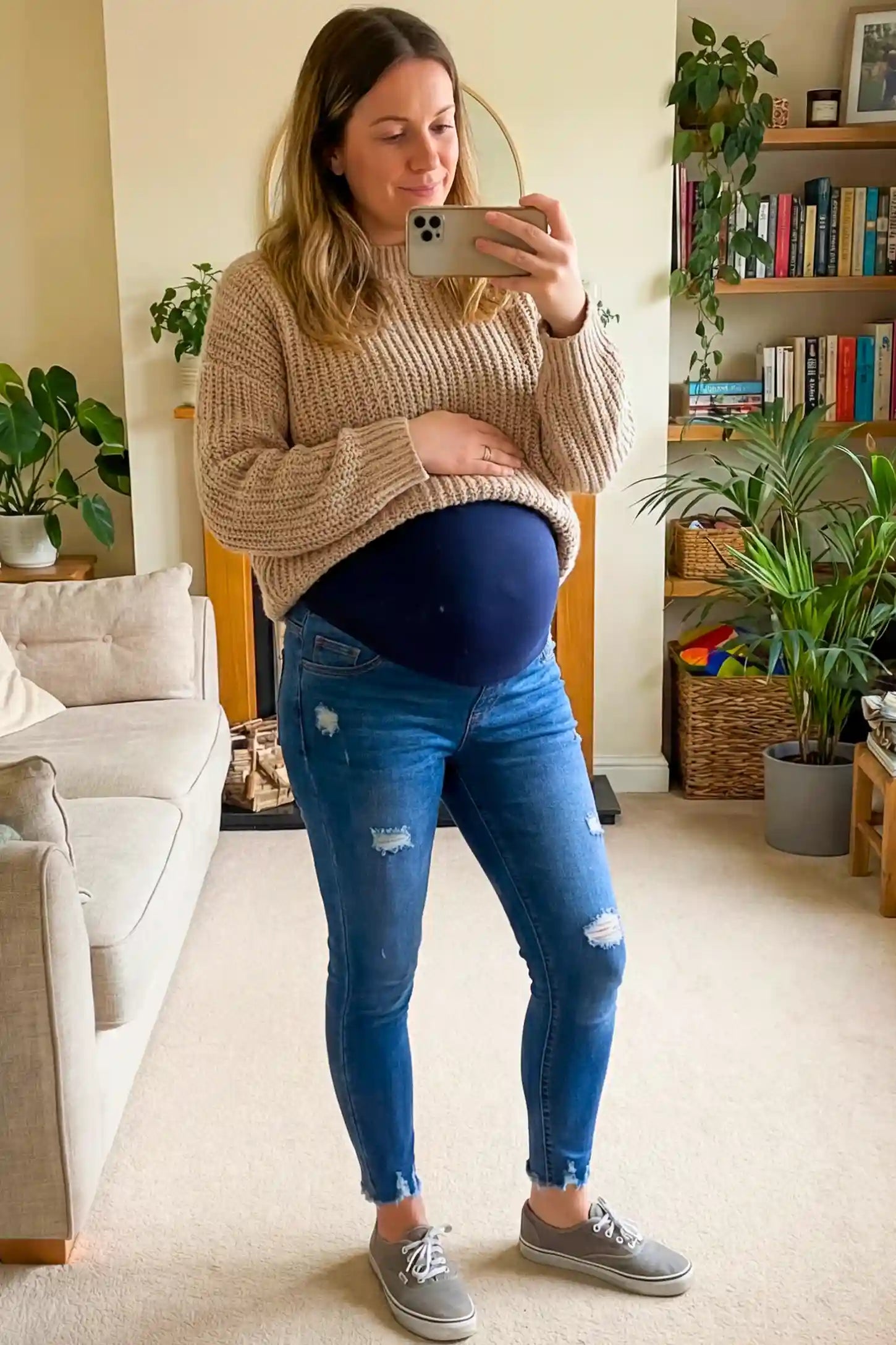 High-Rise Distressed Skinny Maternity Jeans High-Rise Distressed Skinny Maternity Jeans in navy blue featuring over-the-belly support panel and frayed hem on a pregnant model.