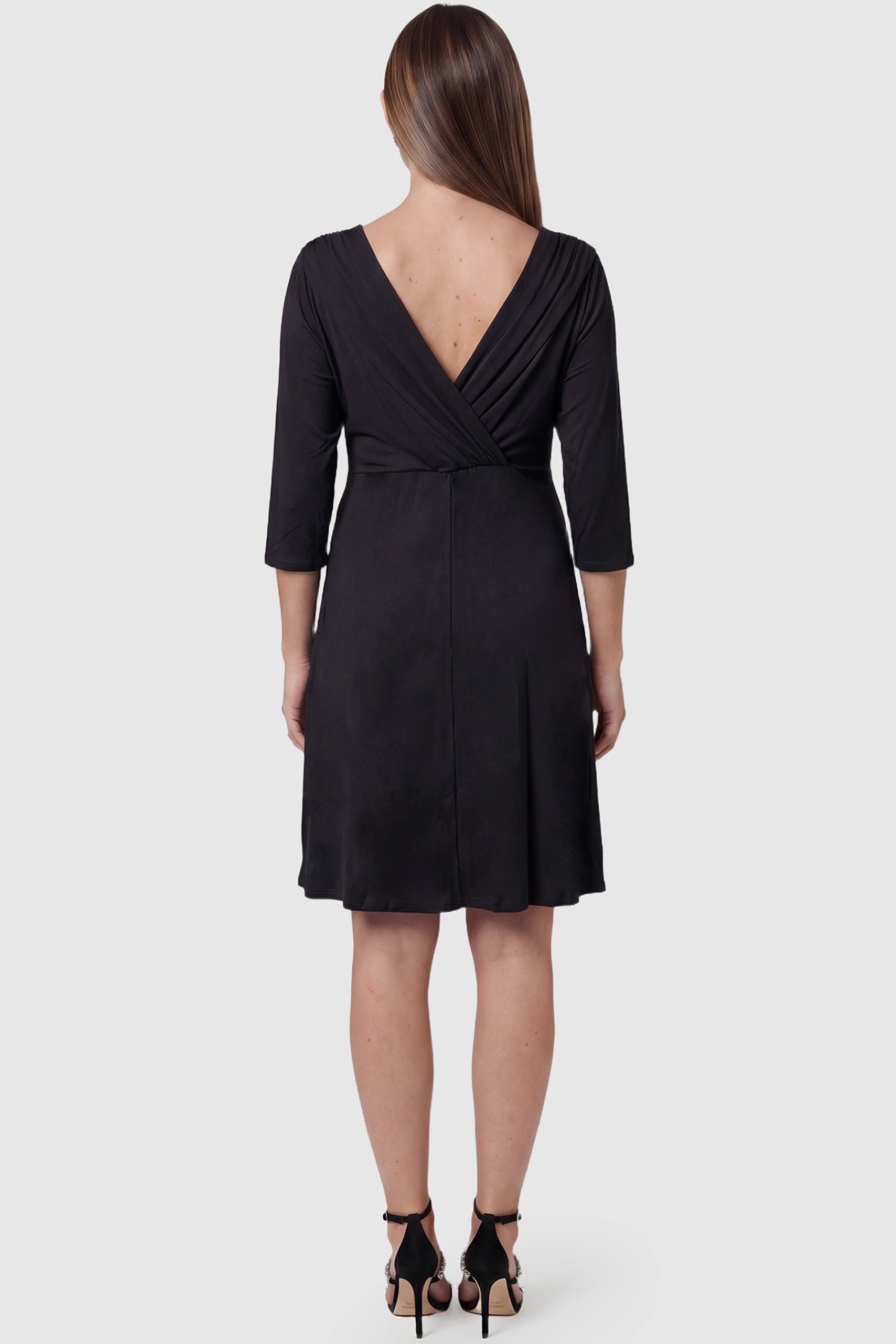 Crossover A-Line Maternity & Nursing Midi Dress Crossover A-line maternity & nursing midi dress in black with bump-flattering empire waist, side view on pregnant model