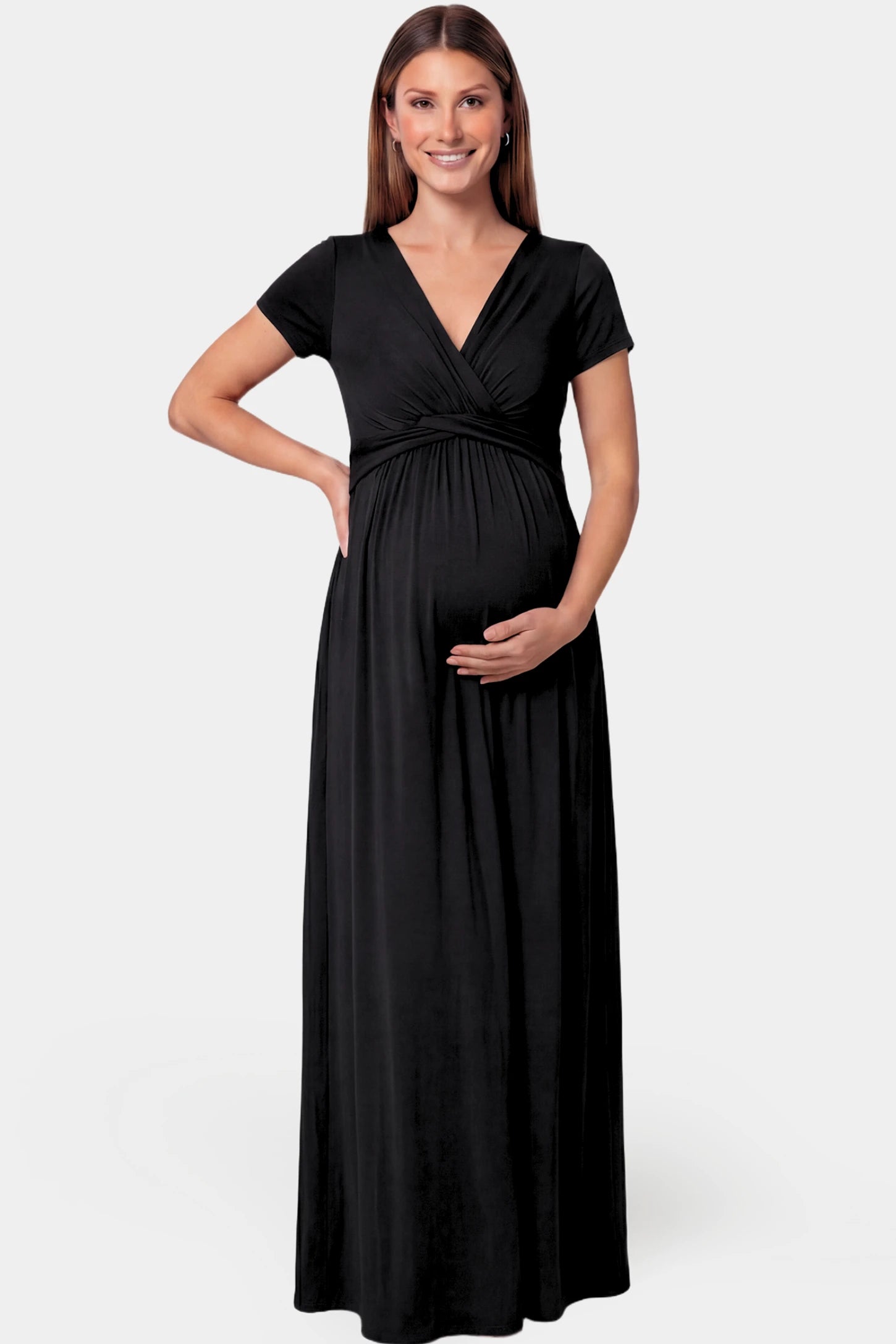 Crossover Draped Maternity & Nursing Maxi Dress Crossover Draped Maternity & Nursing Maxi Dress in black featuring a V-neck crossover design and flowy empire waist silhouette on a pregnant model.