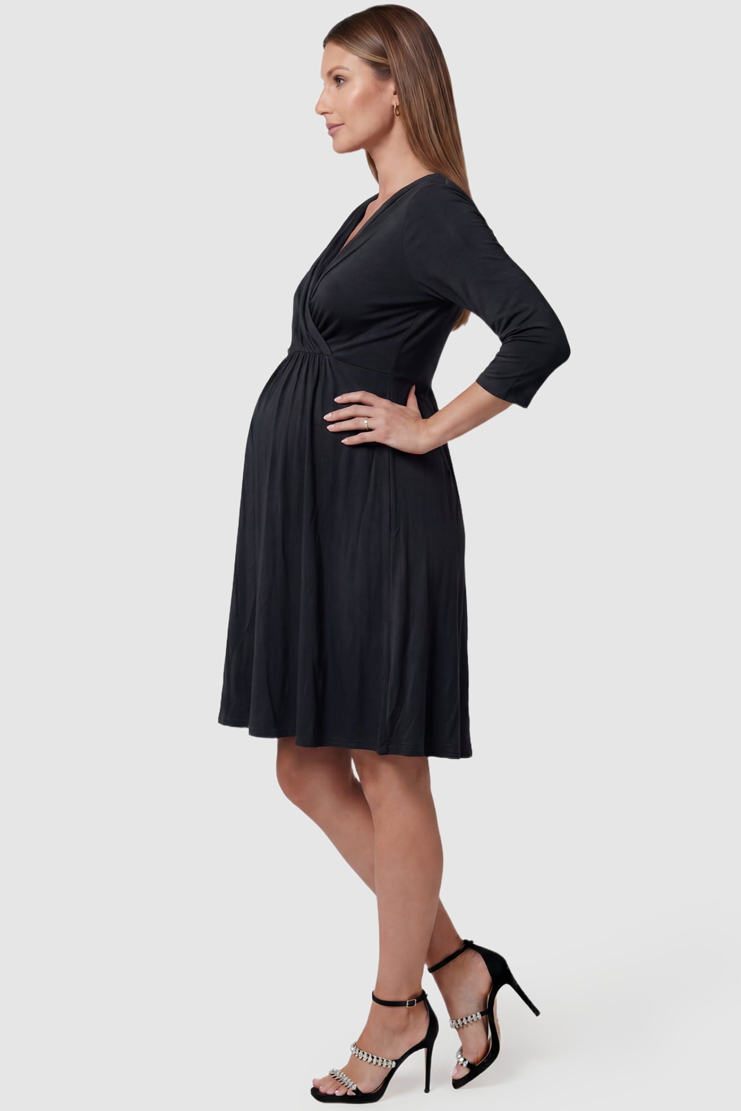 Crossover A-Line Maternity & Nursing Midi Dress Crossover A-Line Maternity & Nursing Midi Dress in black featuring wrap V-neck bodice and flowy midi skirt on pregnant model.