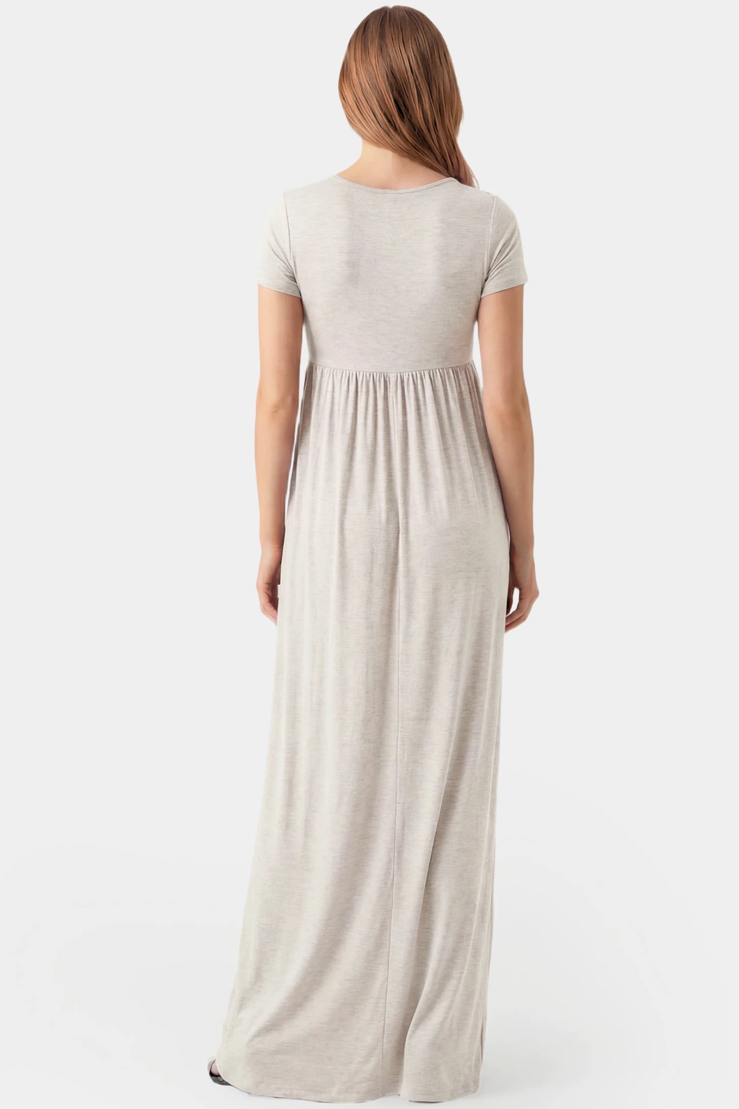 Crossover Draped Maternity & Nursing Maxi Dress Crossover Draped Maternity & Nursing Maxi Dress in light gray featuring a flowy empire waist silhouette on a pregnant model.