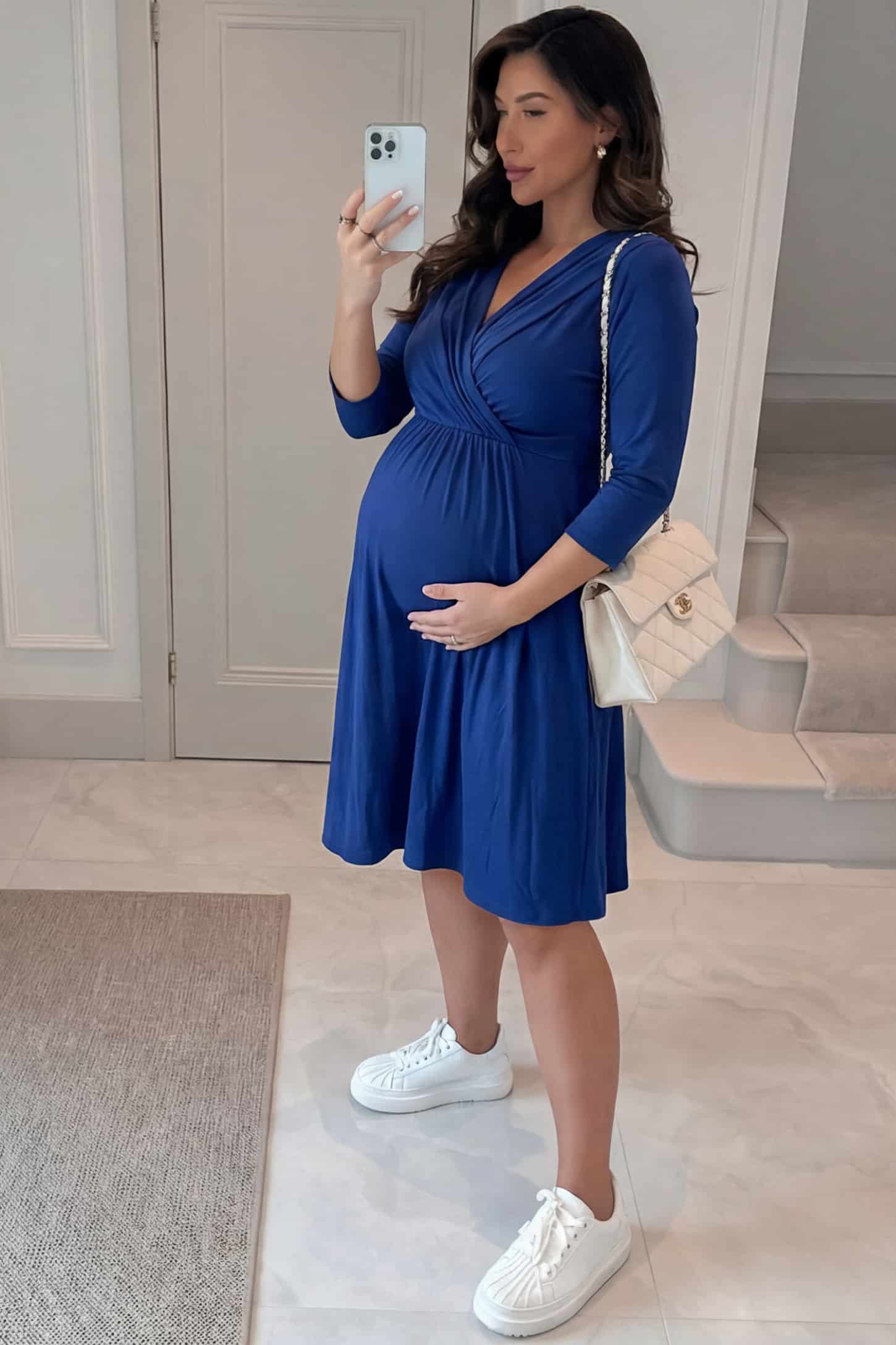 Crossover A-Line Maternity & Nursing Midi Dress Crossover A-Line Maternity & Nursing Midi Dress in navy blue featuring wrap V-neck bodice and flowy midi skirt on pregnant model.