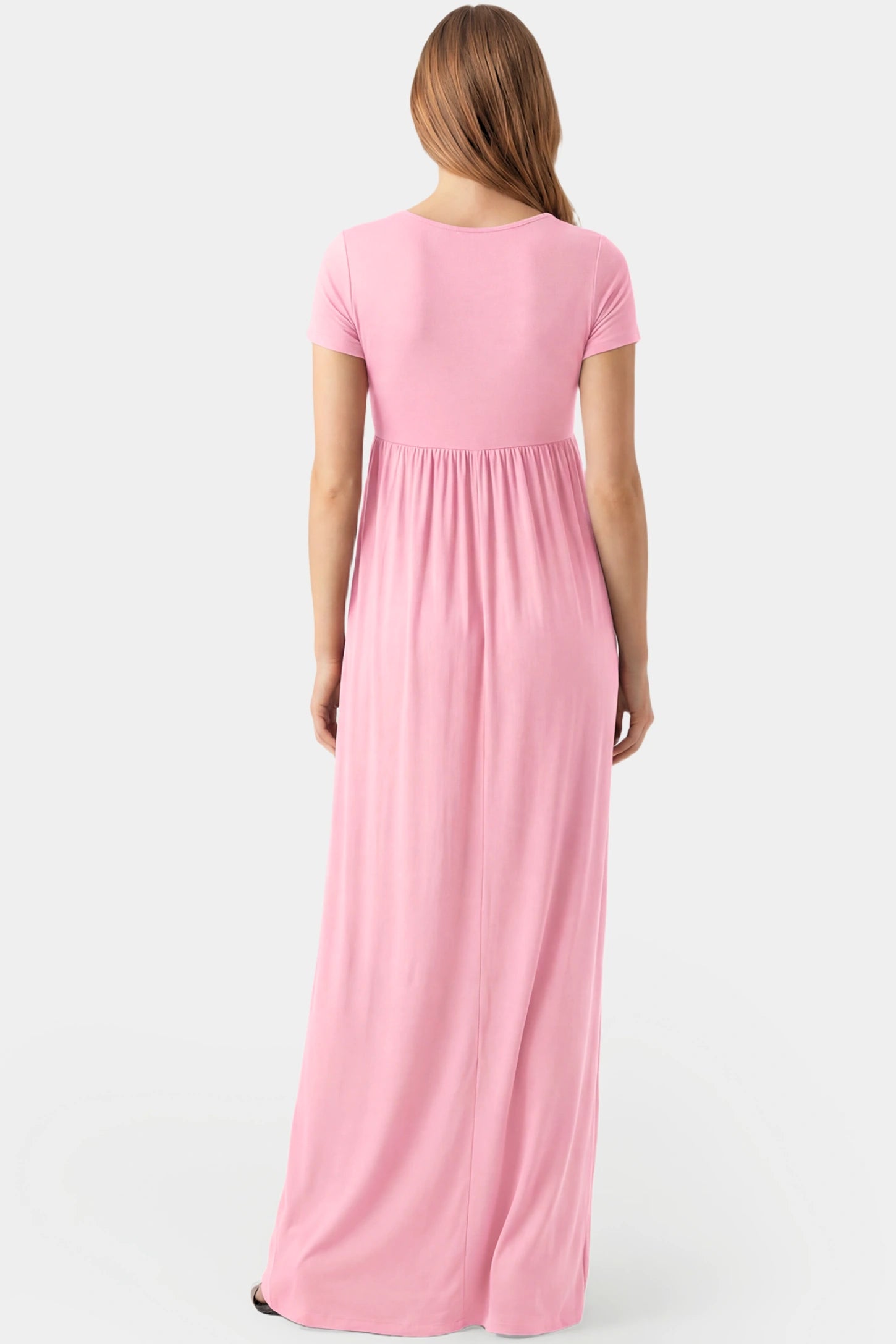 Crossover Draped Maternity & Nursing Maxi Dress Crossover Draped Maternity & Nursing Maxi Dress in pink featuring a flowy empire waist silhouette on a pregnant model.