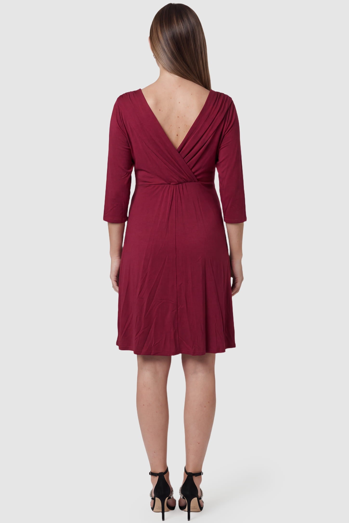 Crossover A-Line Maternity & Nursing Midi Dress Crossover A-Line Maternity & Nursing Midi Dress in red featuring V-back and flowy midi skirt on pregnant model.