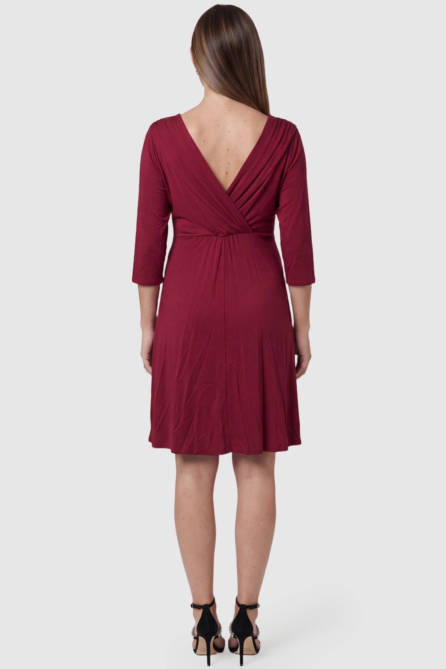 Crossover A-Line Maternity & Nursing Midi Dress Crossover A-line maternity & nursing midi dress in red with soft pleated drape, back view on pregnant model