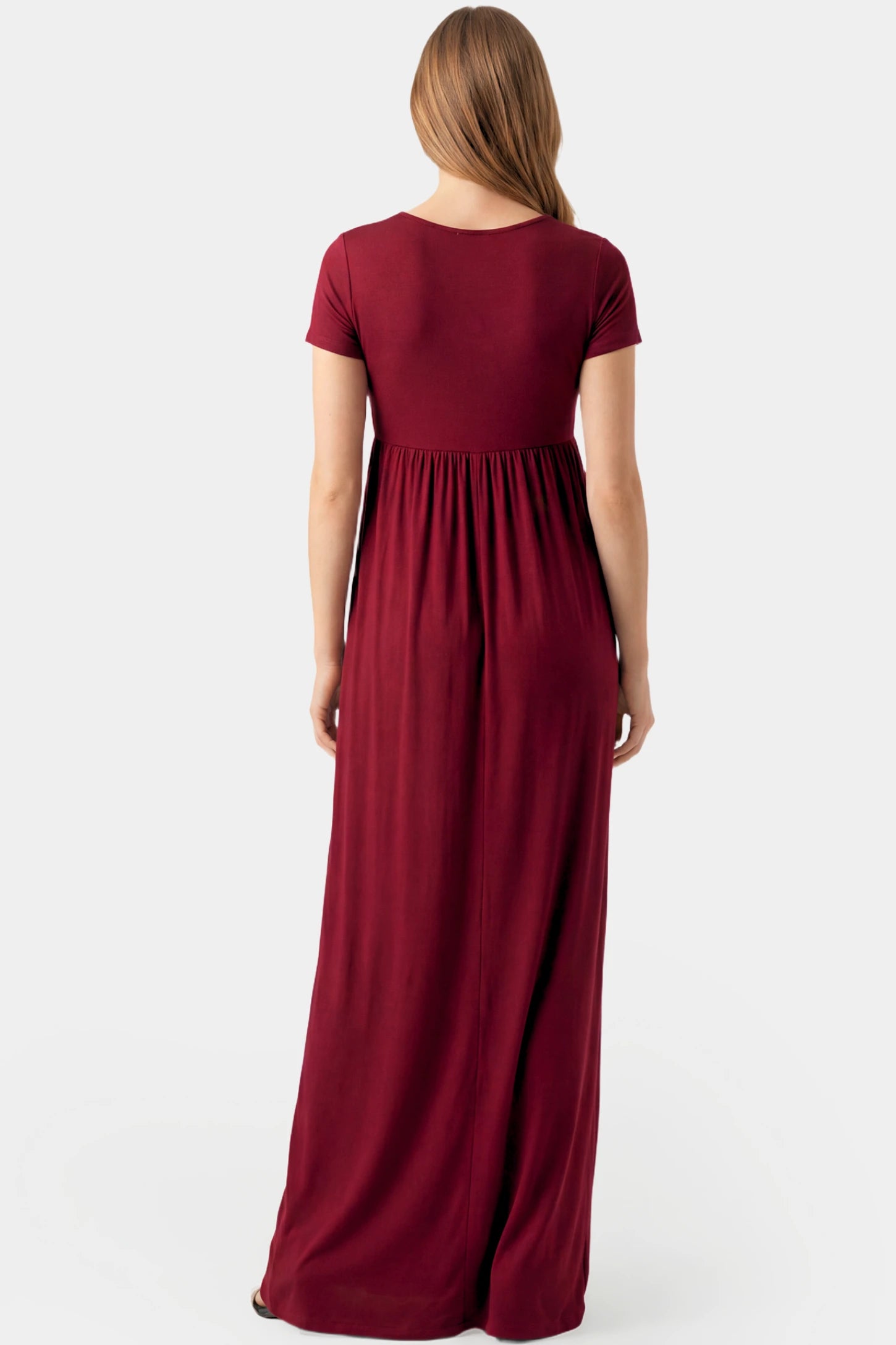 Crossover Draped Maternity & Nursing Maxi Dress Crossover Draped Maternity & Nursing Maxi Dress in red wine featuring a flowy empire waist silhouette on a pregnant model.