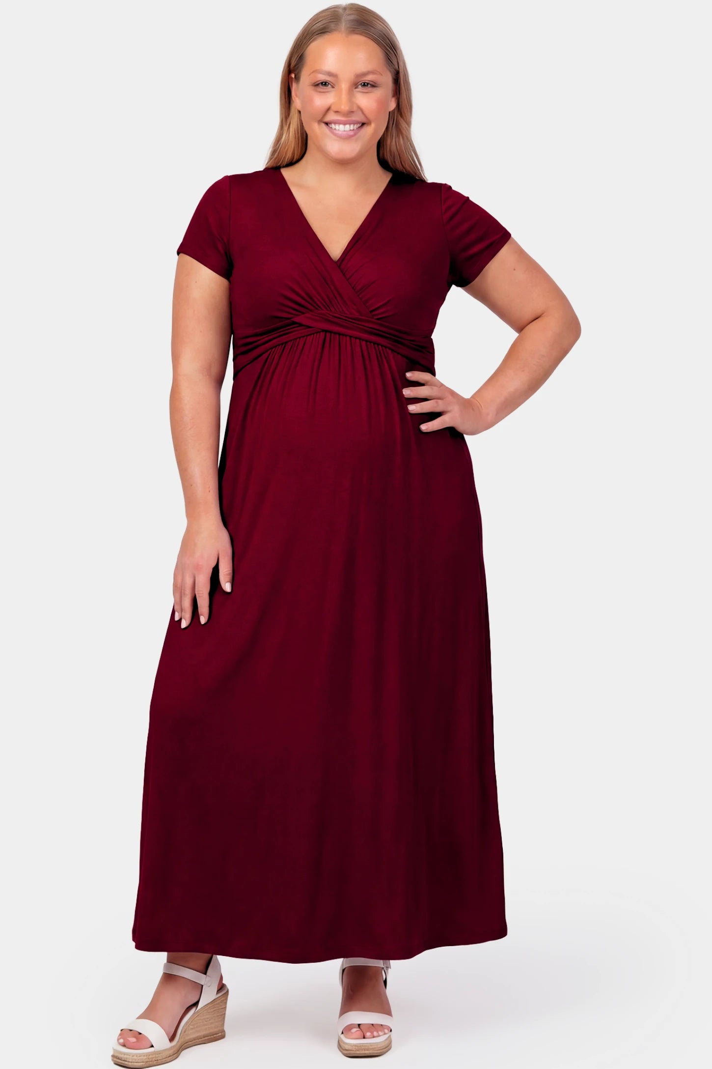 Crossover Draped Maternity & Nursing Maxi Dress Crossover Draped Maternity & Nursing Maxi Dress in red wine featuring a V-neck crossover design and flowy empire waist silhouette on a plus size pregnant model.